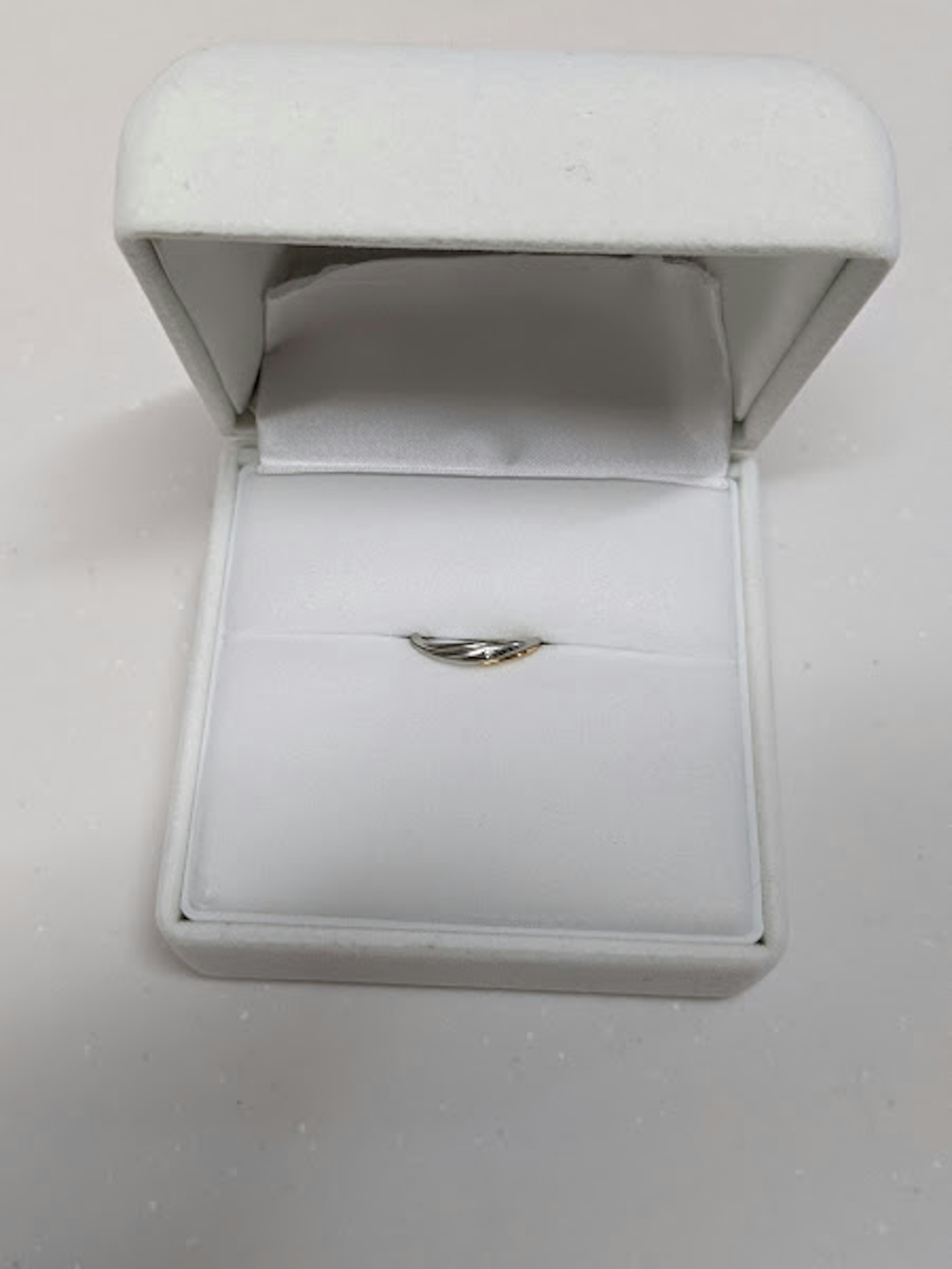 Simple ring displayed in a white jewelry box