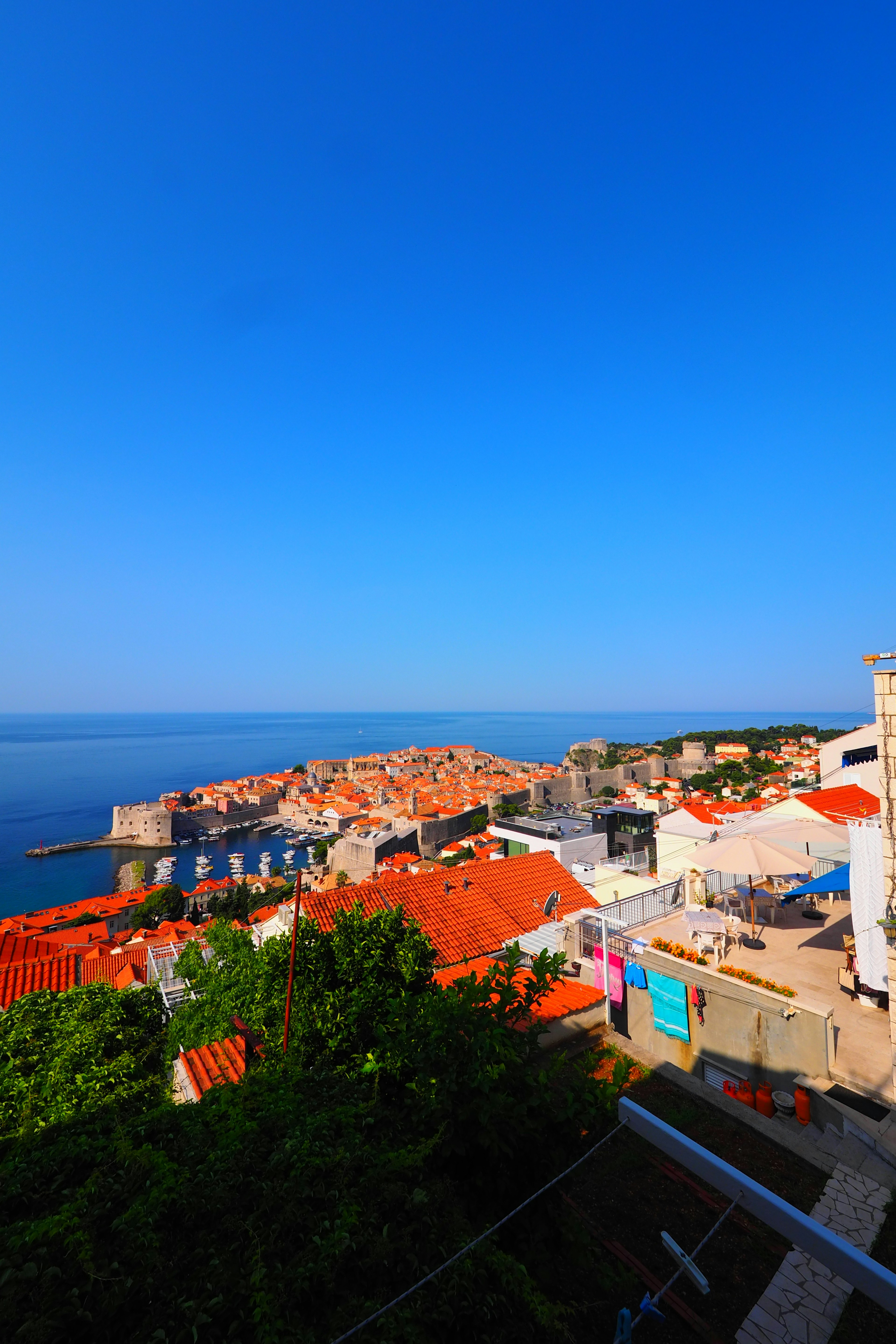 Beautiful coastal view with orange rooftops under a clear blue sky