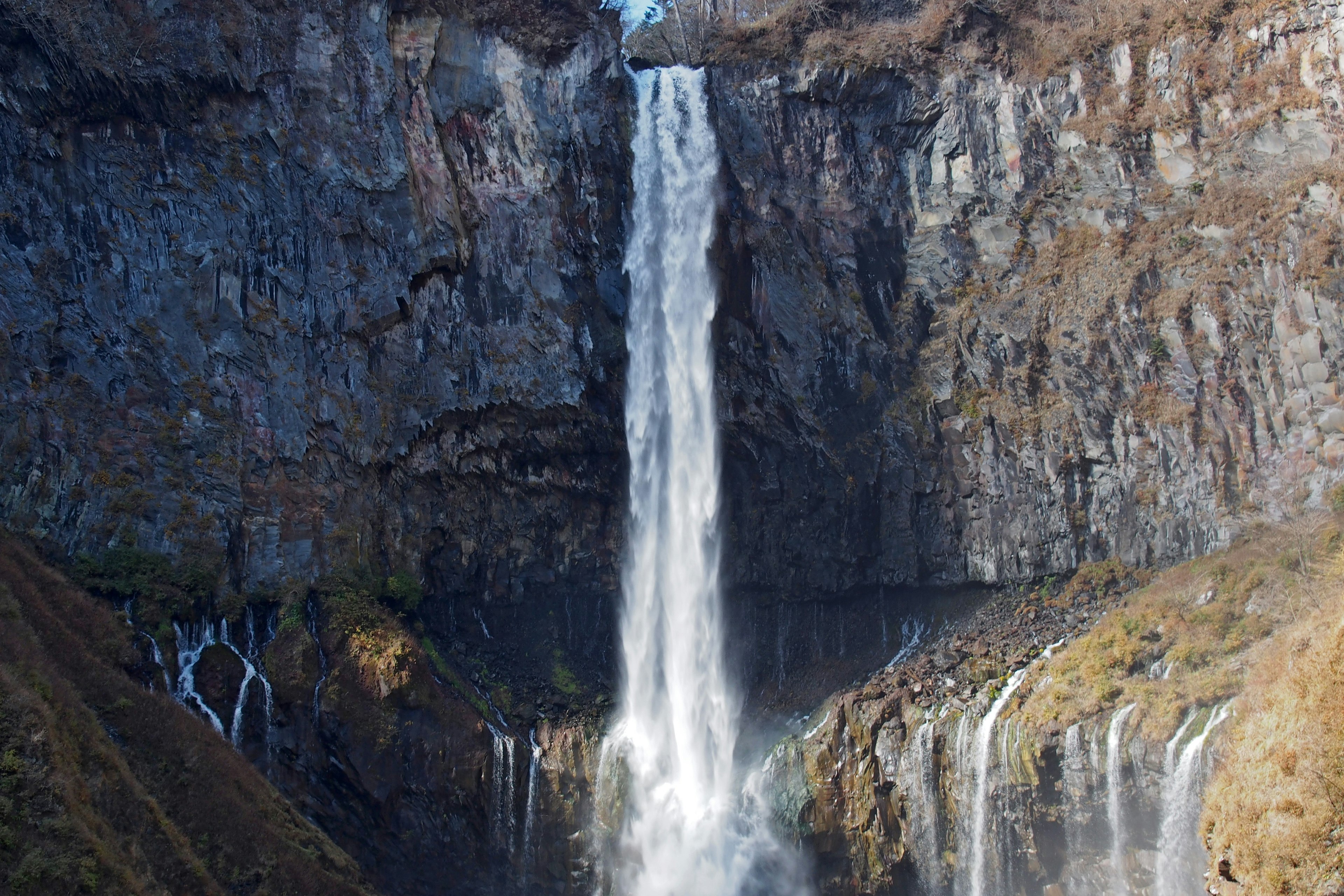 A stunning waterfall cascading down a rocky cliff in a natural landscape