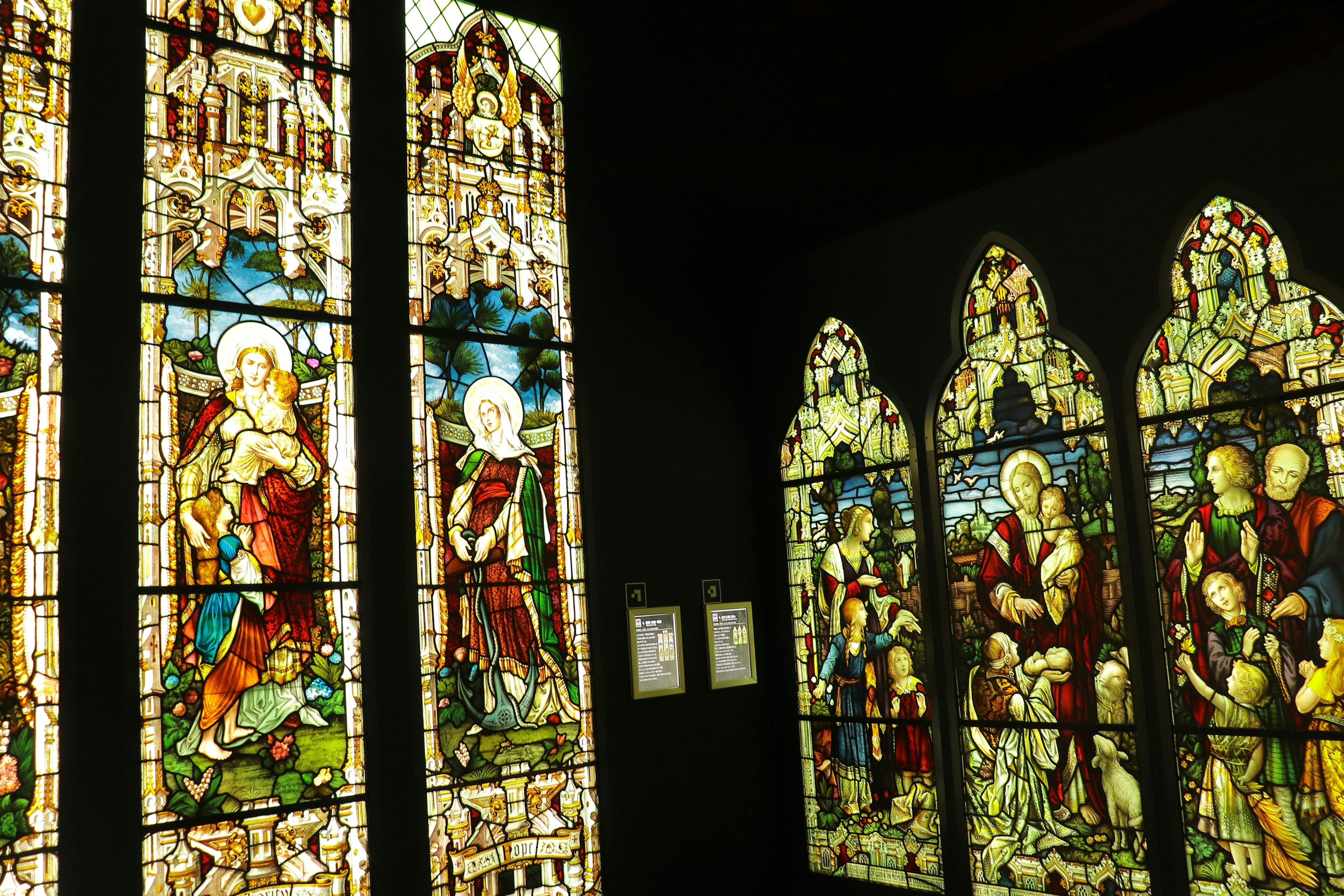 Interior of a church featuring colorful stained glass windows