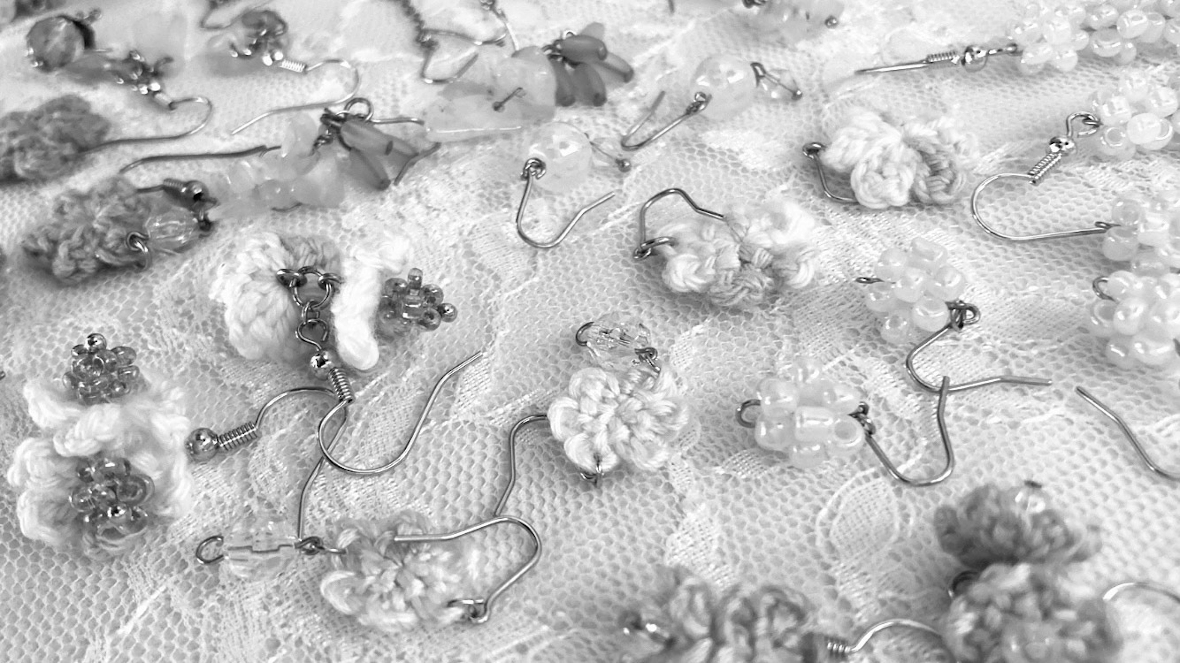 Close-up of embroidered floral patterns on fabric in black and white