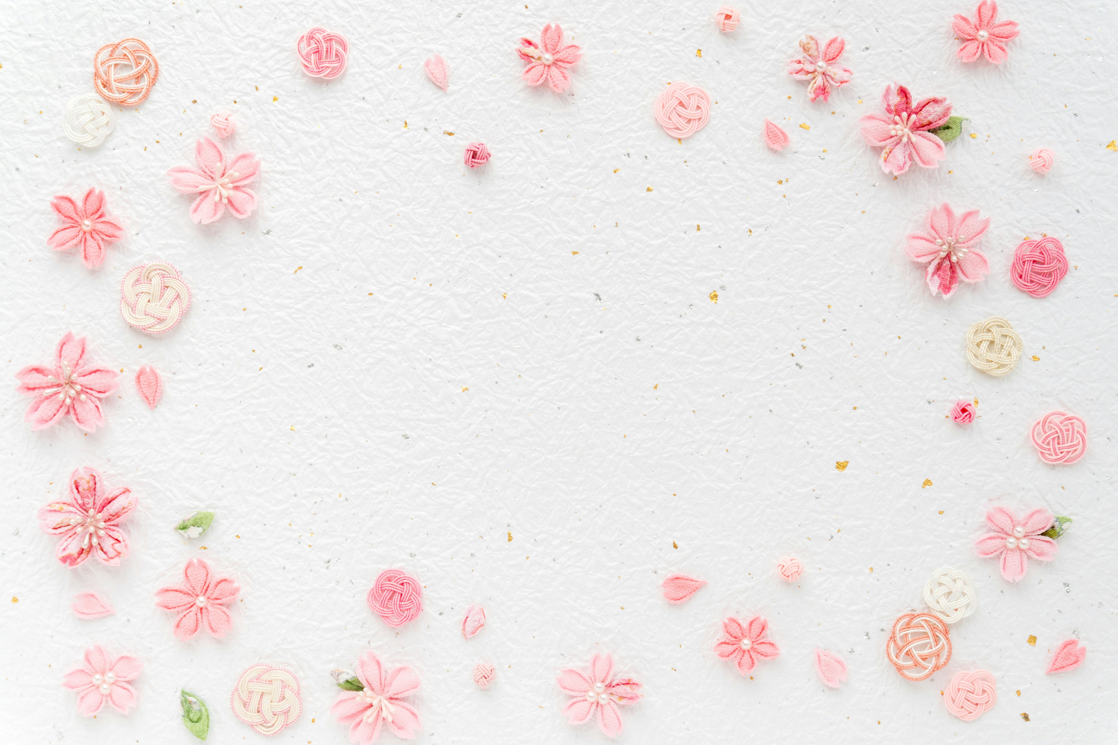 Design featuring scattered pink flower petals on a white background