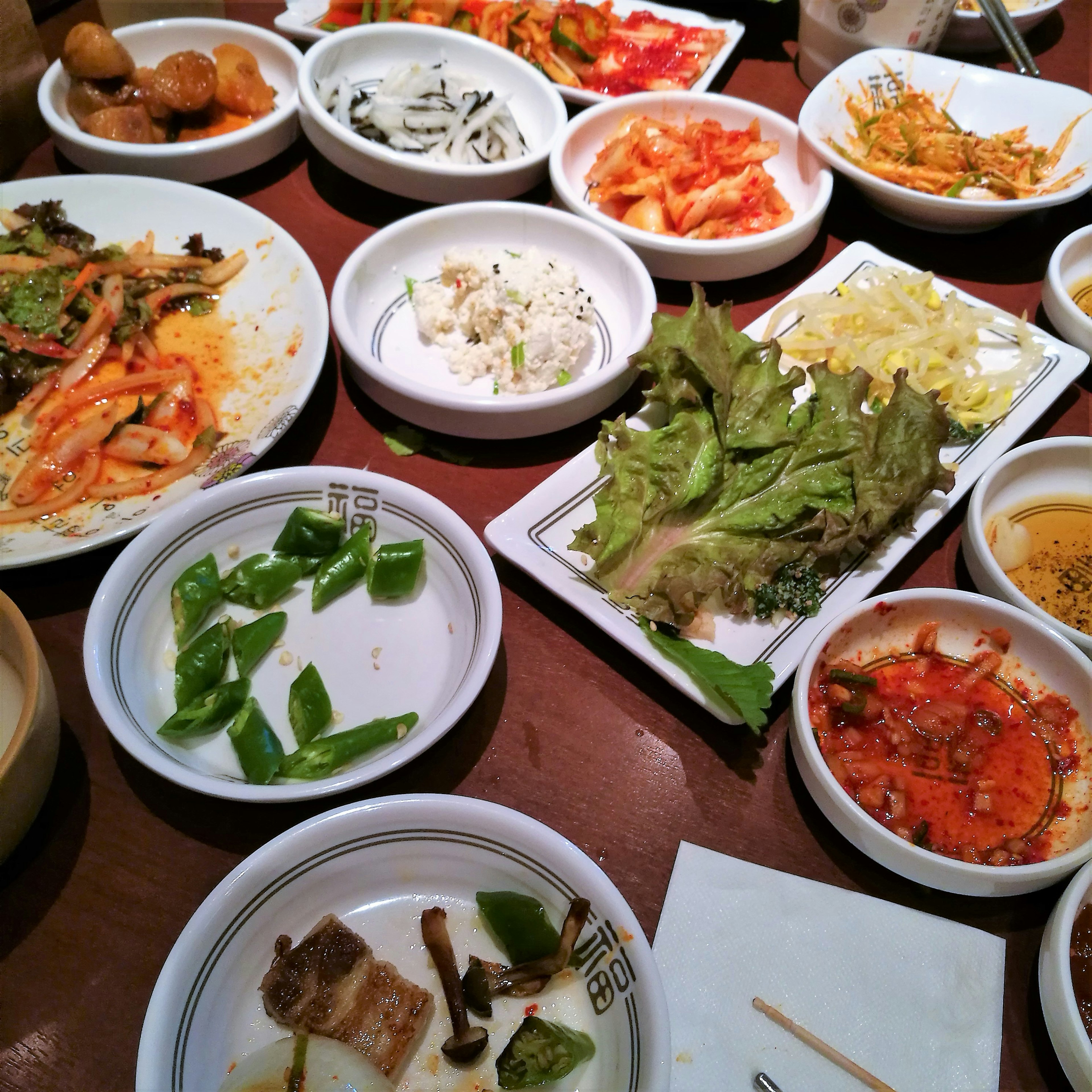 Table filled with various Korean banchan dishes