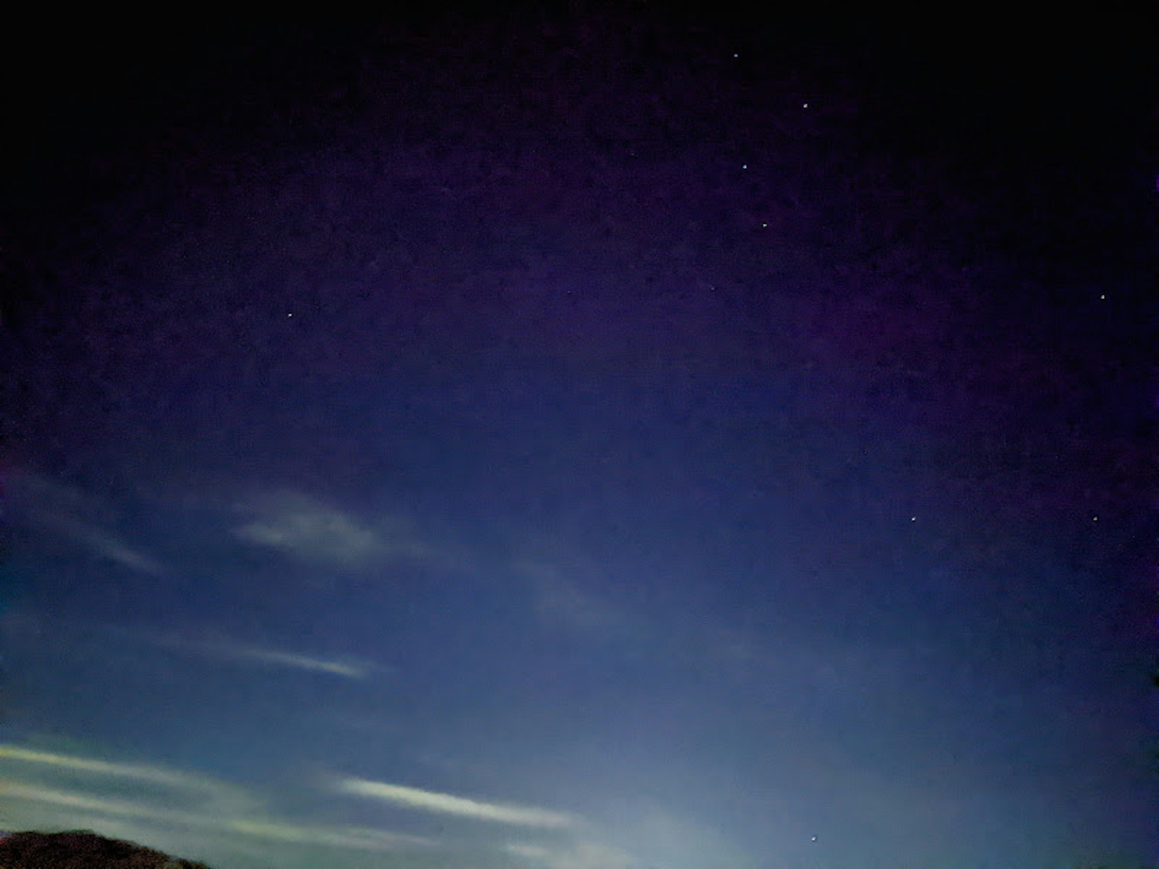 Starlit night sky with wispy clouds