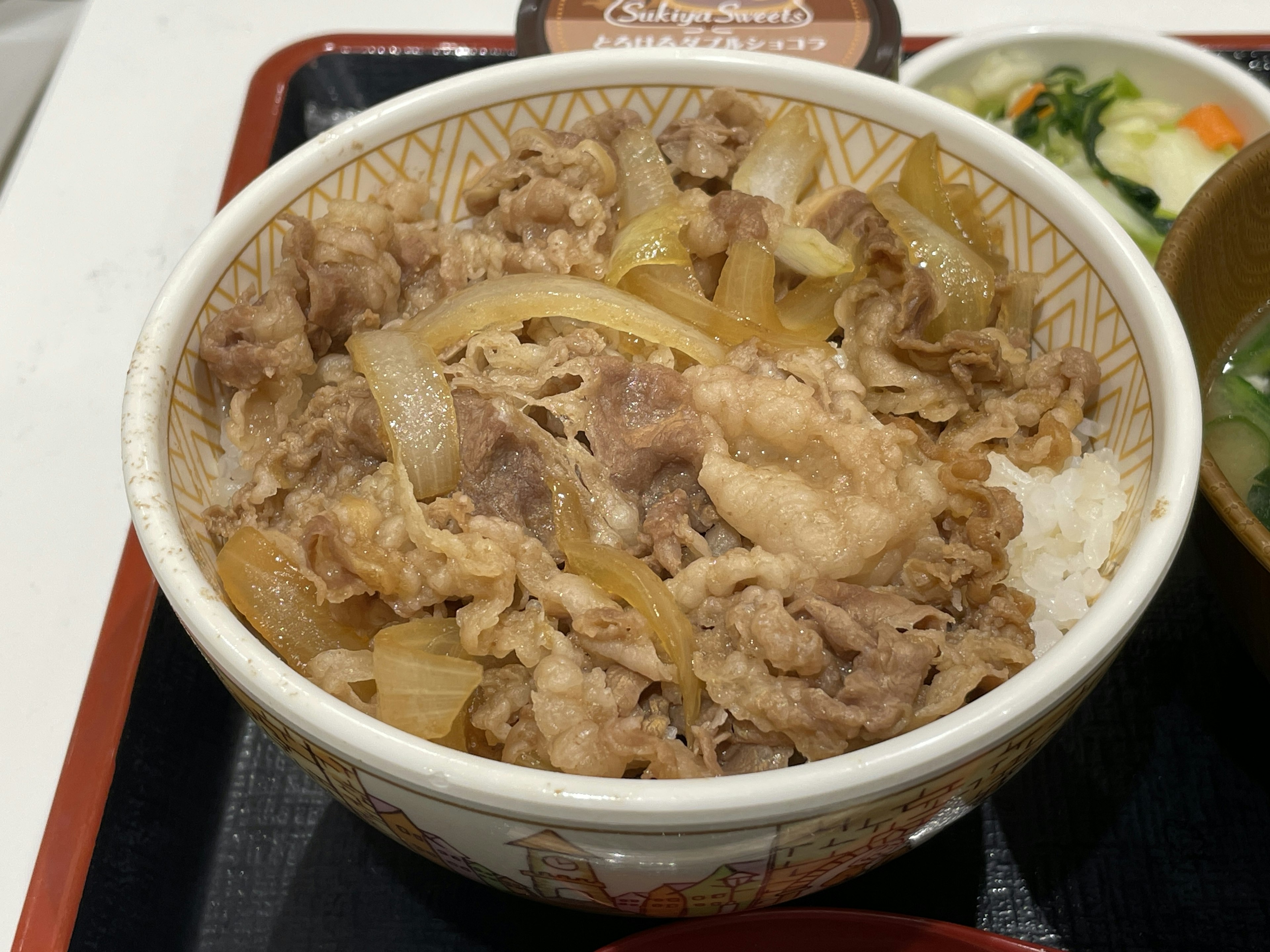 牛丼の丼に盛られた薄切りの牛肉と玉ねぎ