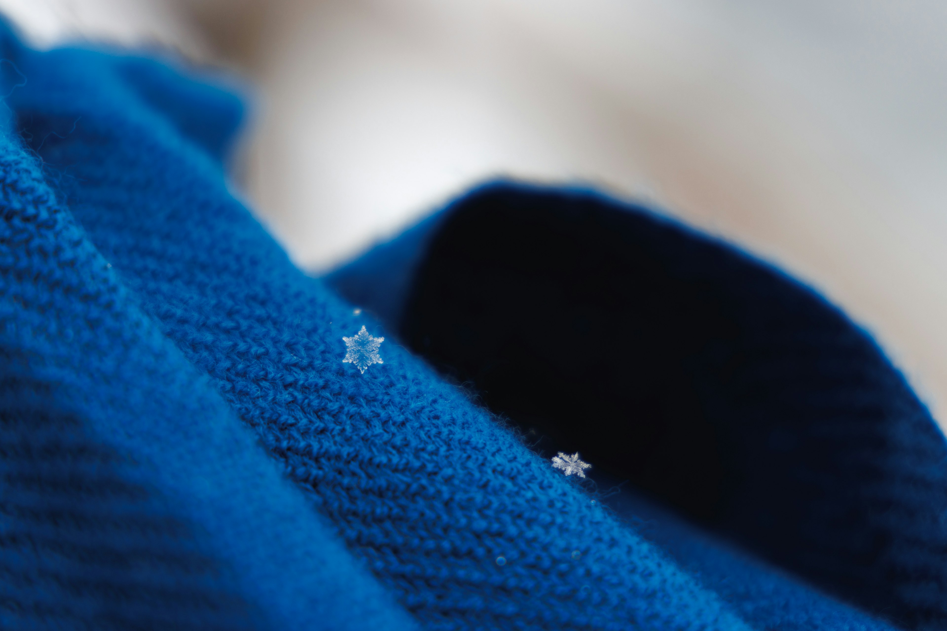 Snowflakes on a blue knitted fabric