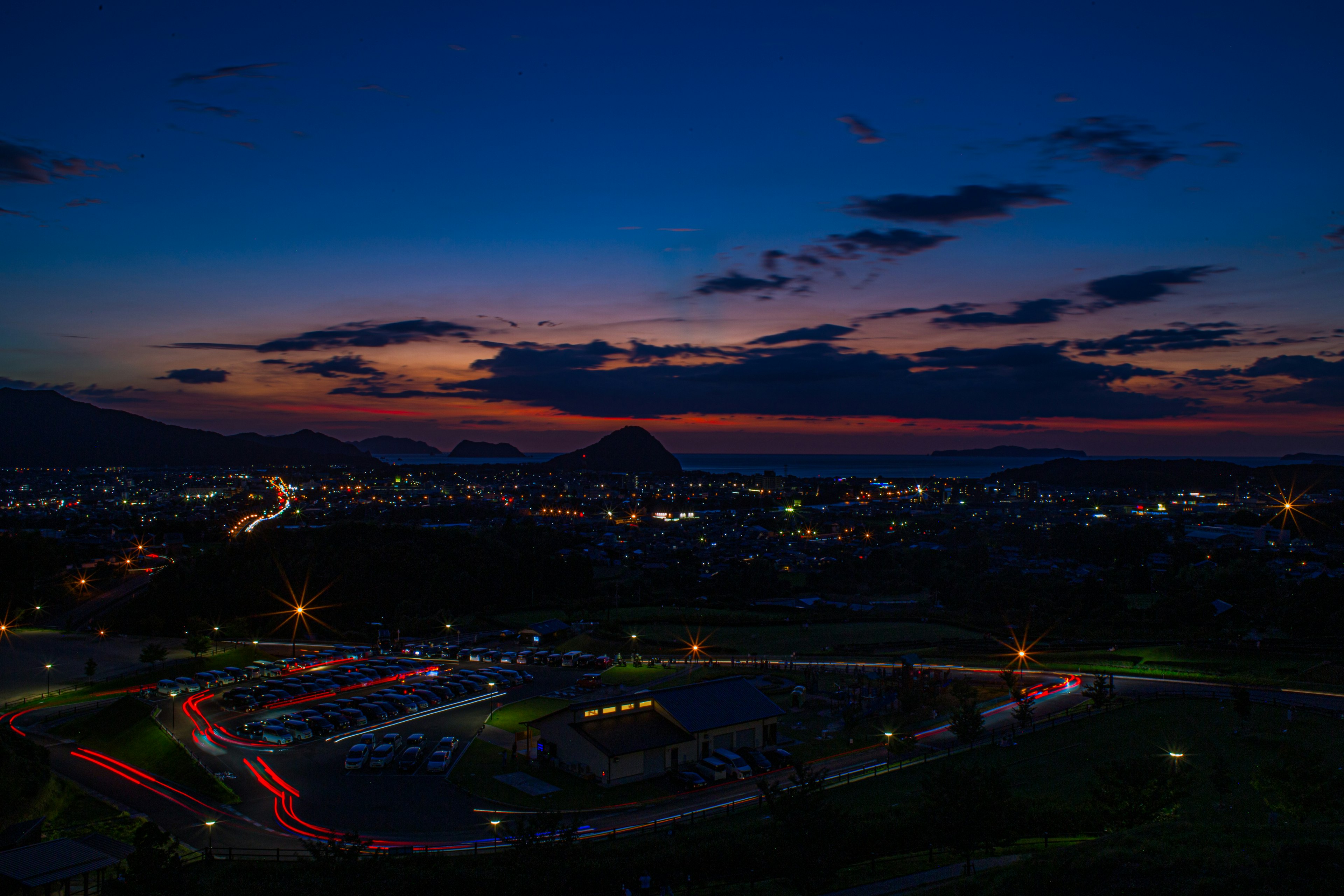 Panoramic view of a city during twilight blue sky and orange sunset city lights glowing