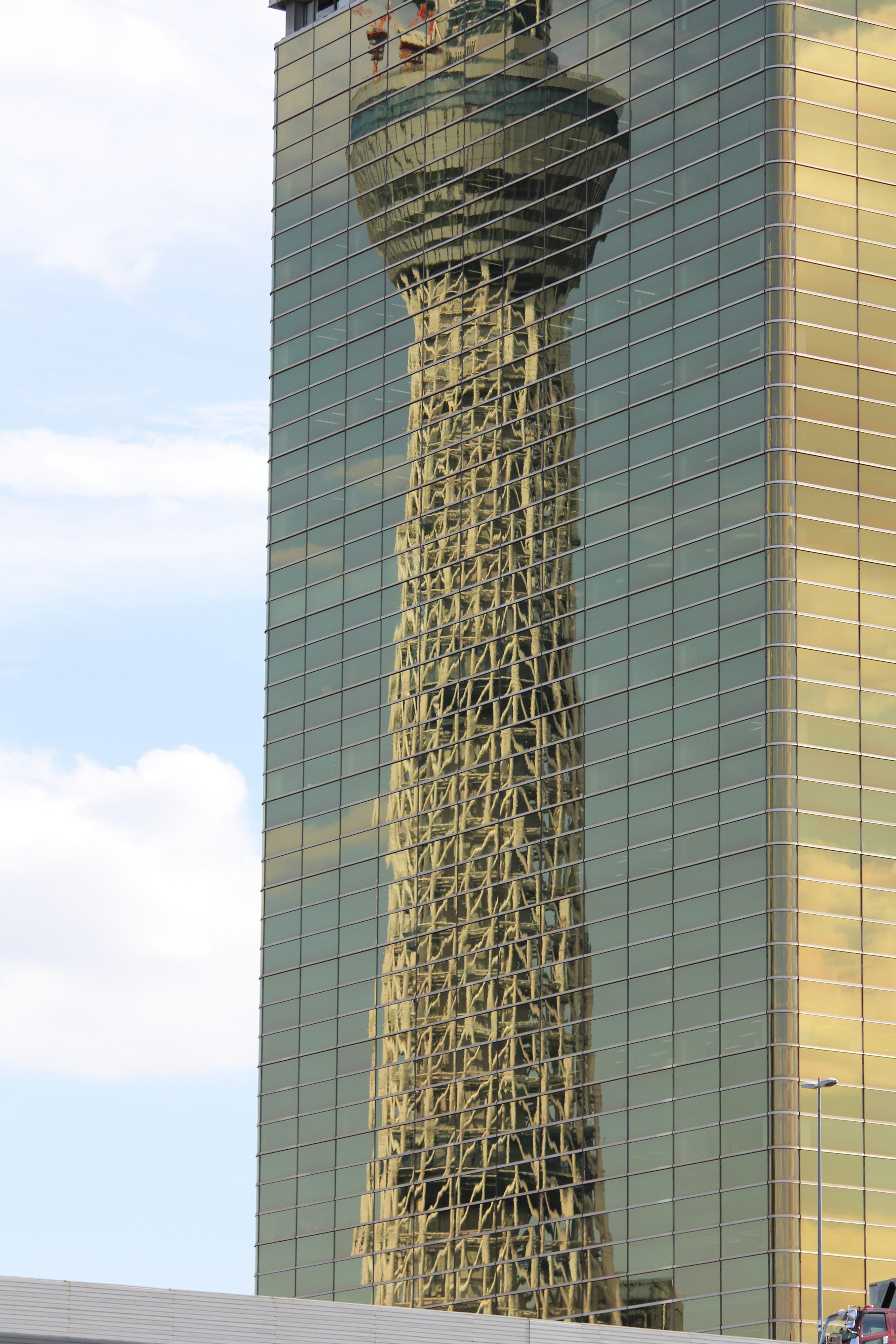 Unique design of a tower reflected in a skyscraper