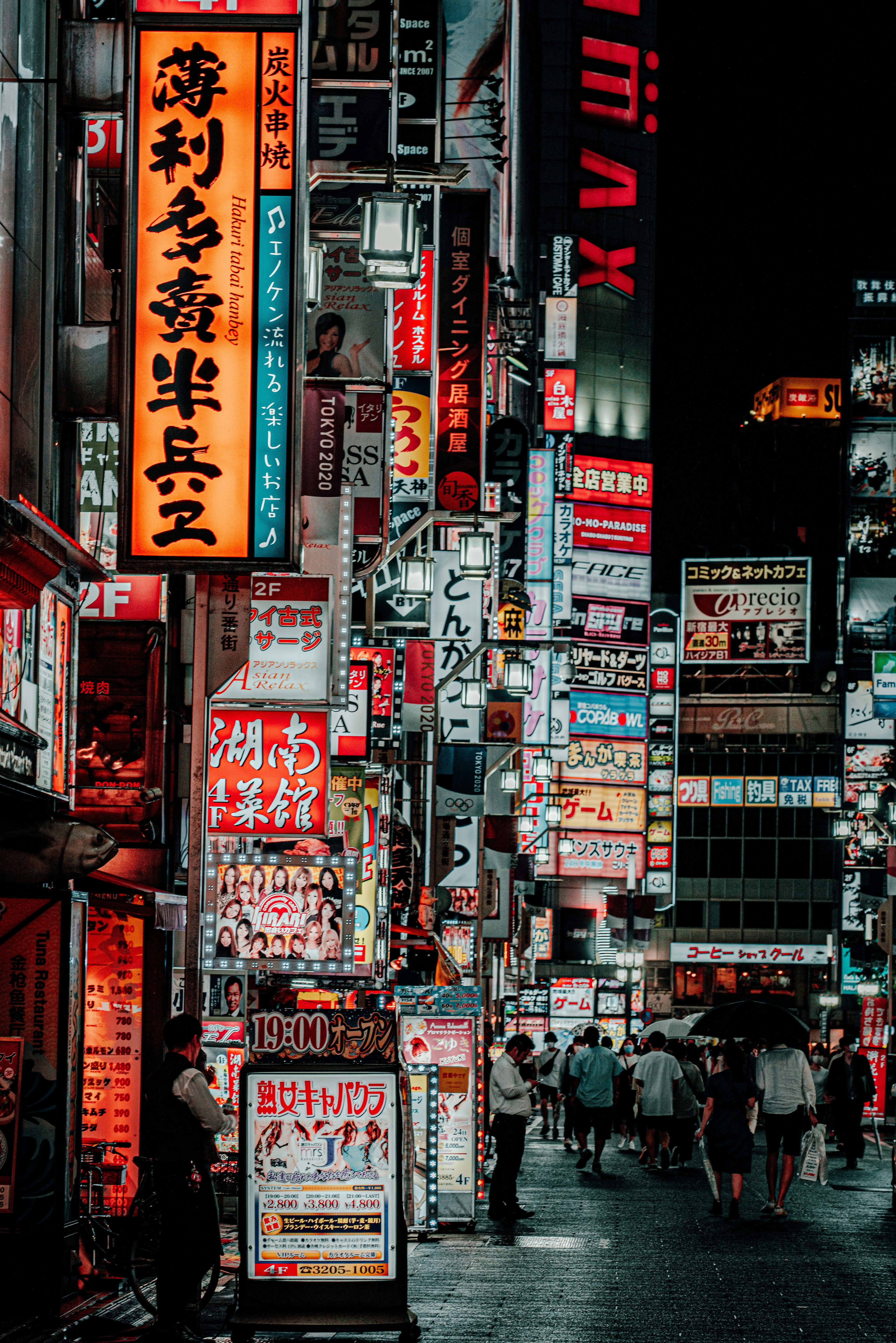 Vibrant urban street scene at night with bright neon signs