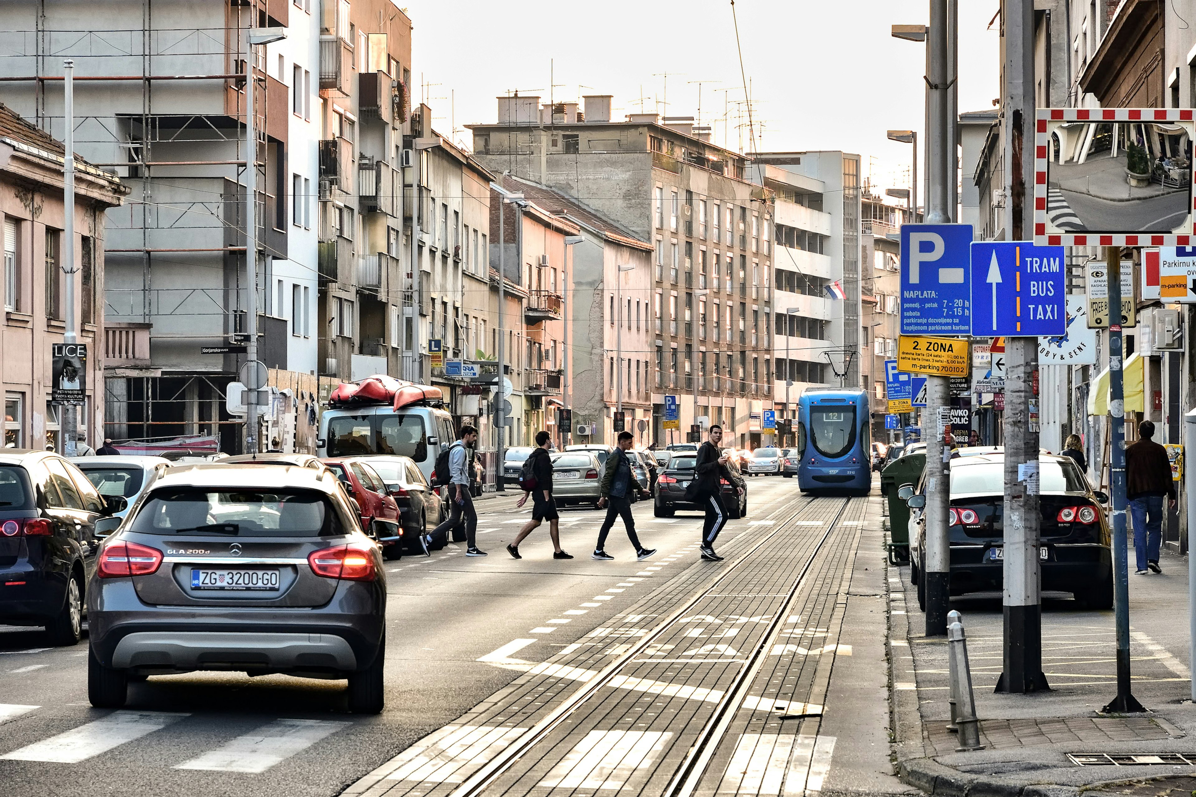 Busy street intersection with pedestrians and vehicles