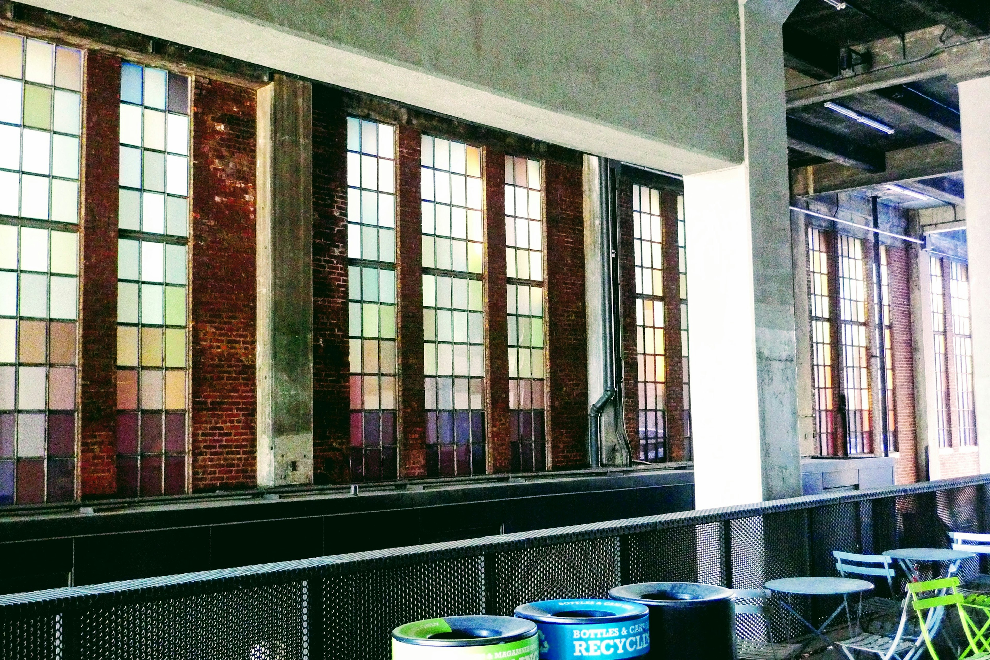 Industrial interior featuring large windows with colorful glass panes