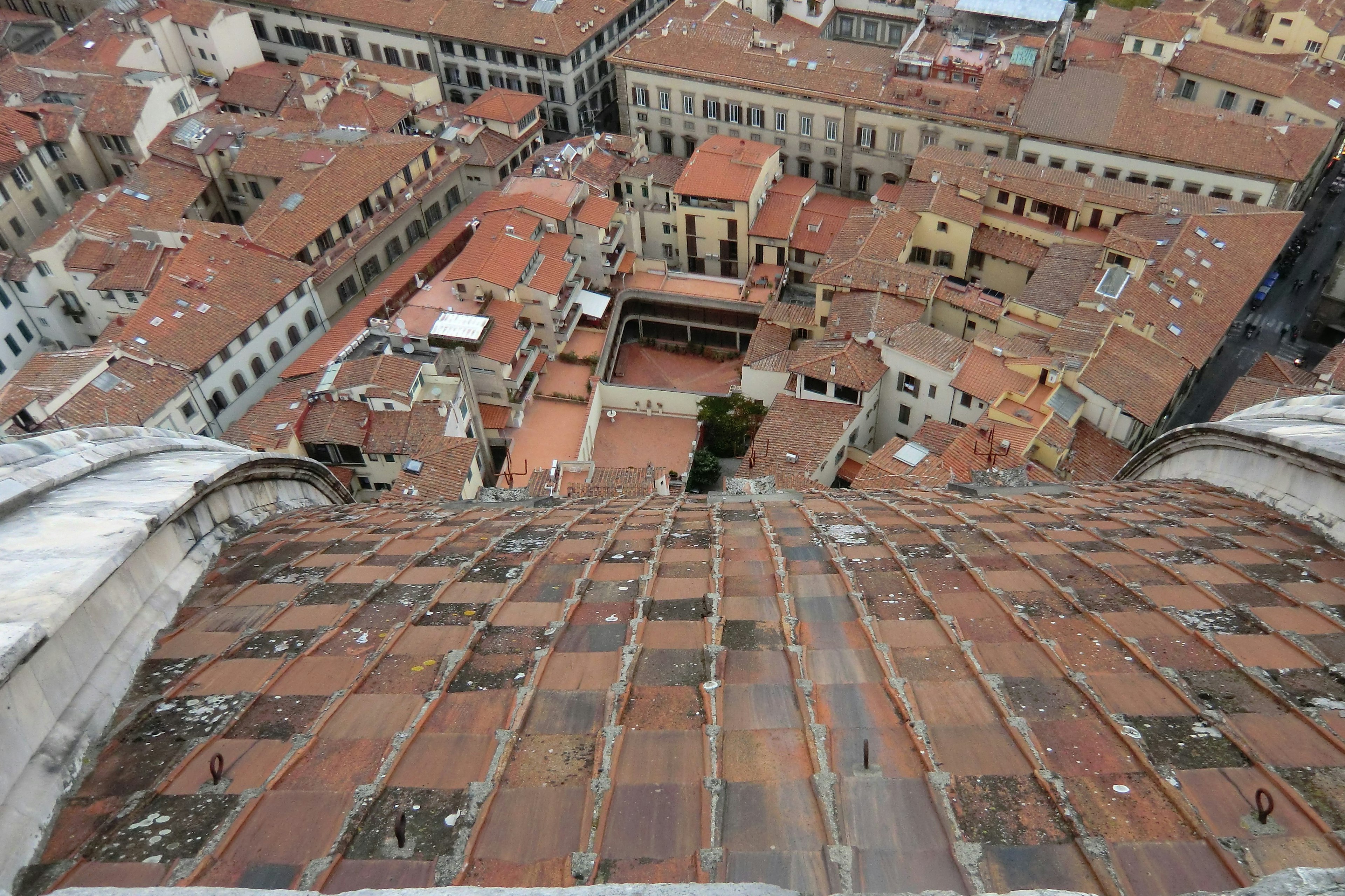 View from the rooftop in Florence showing terracotta tiles and a courtyard