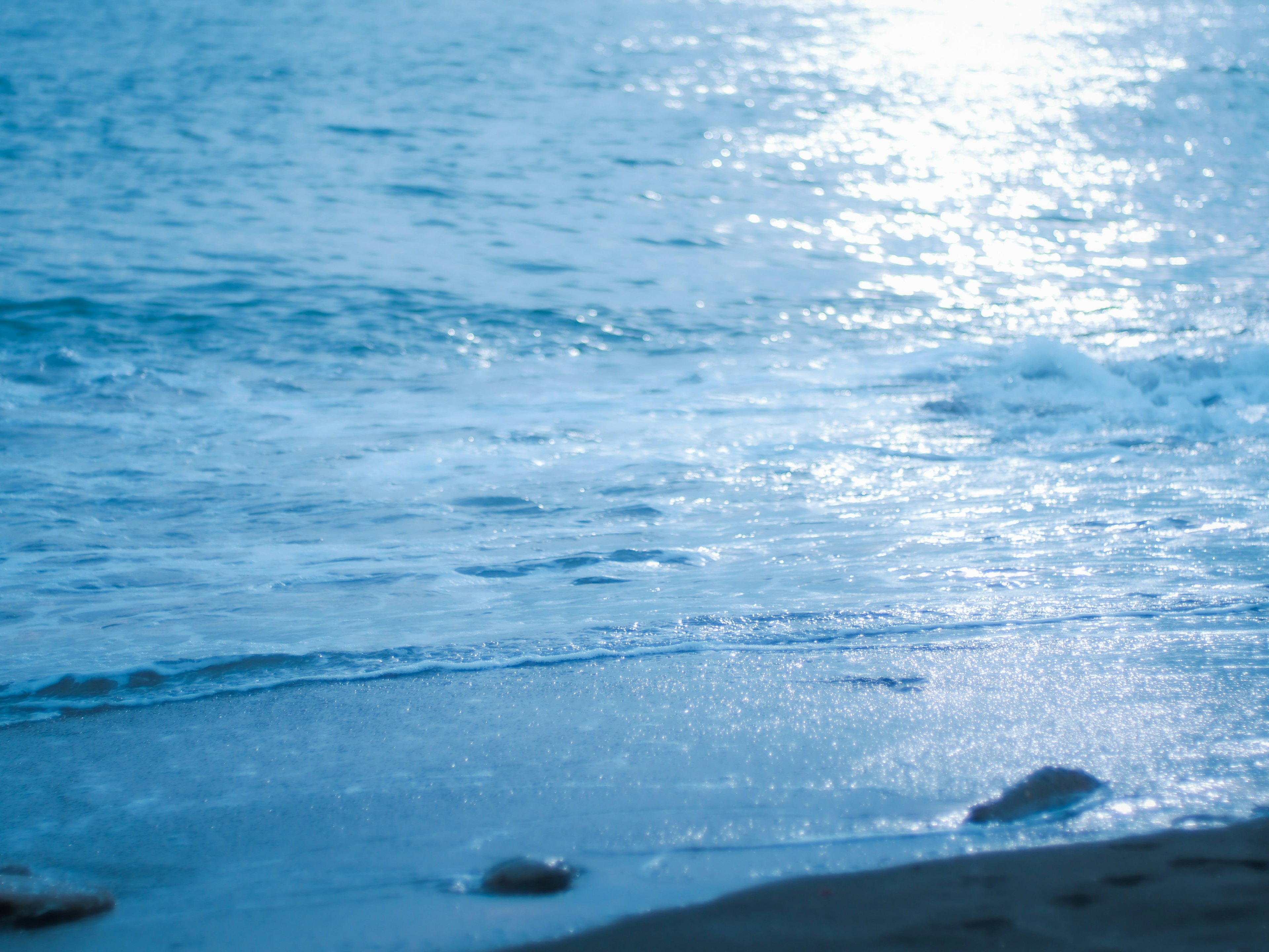 Vue pittoresque de l'océan bleu et de la plage de sable avec de belles reflets d'eau