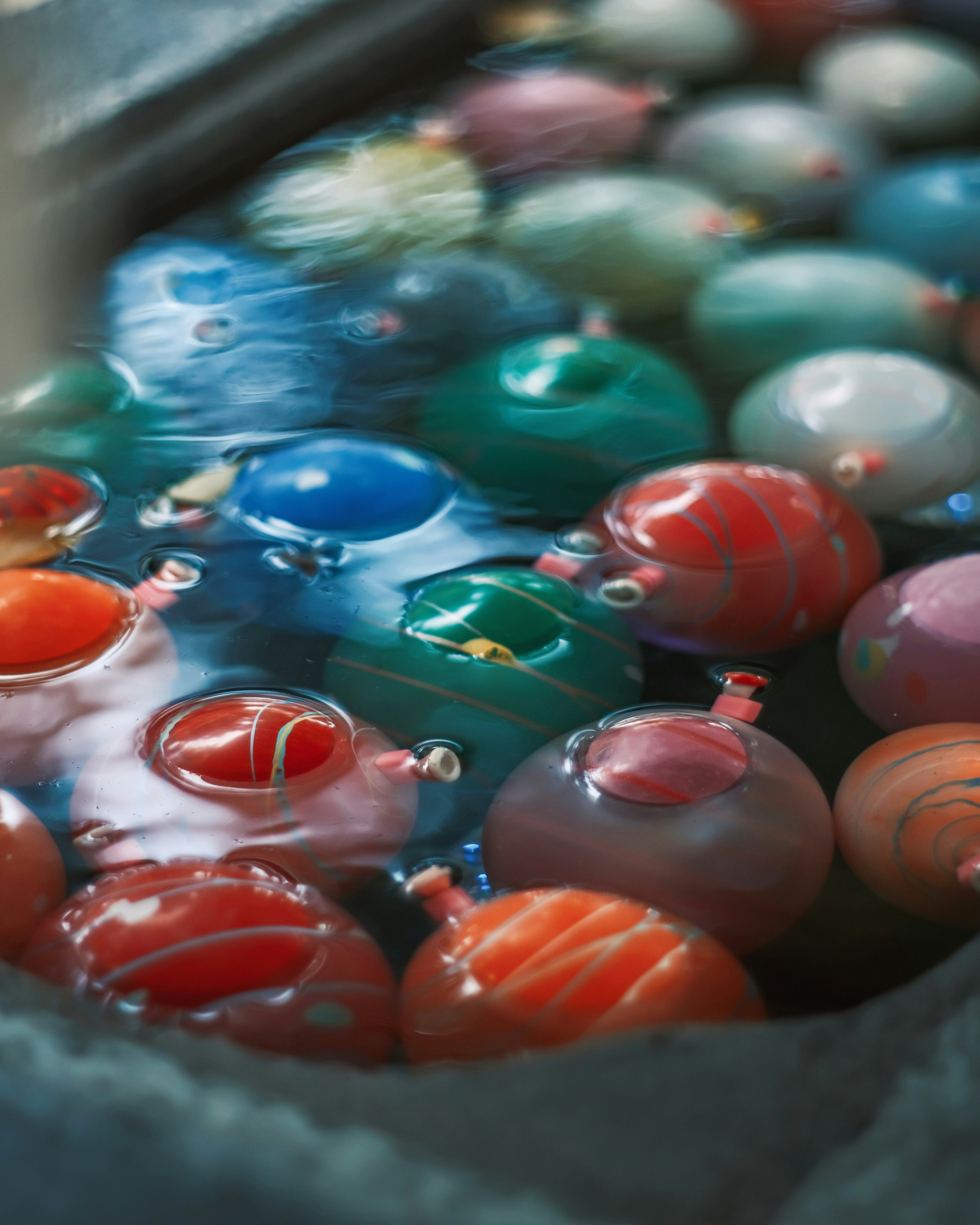 A collection of colorful balls floating in water