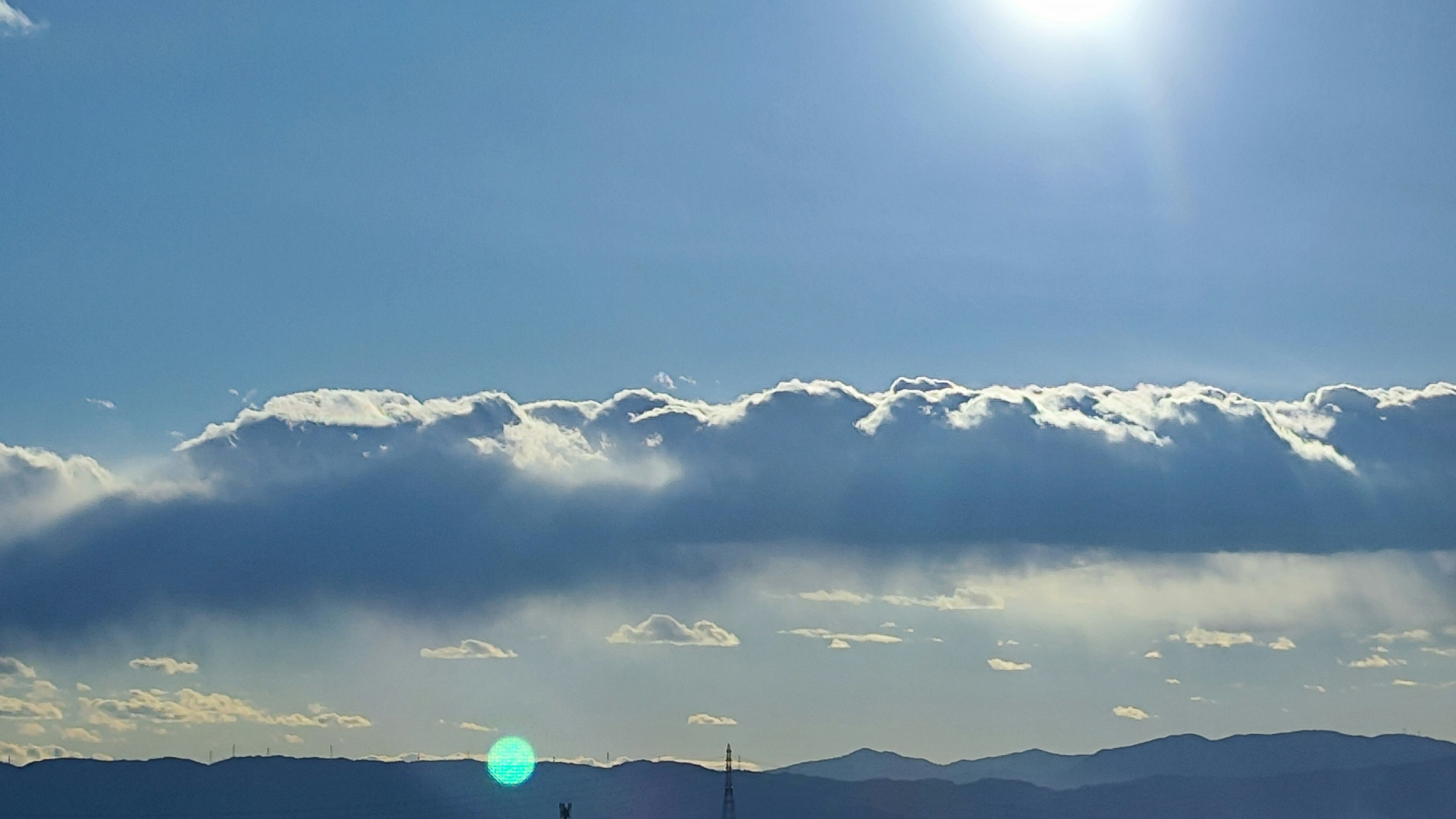 Clouds floating in a blue sky with sunlight