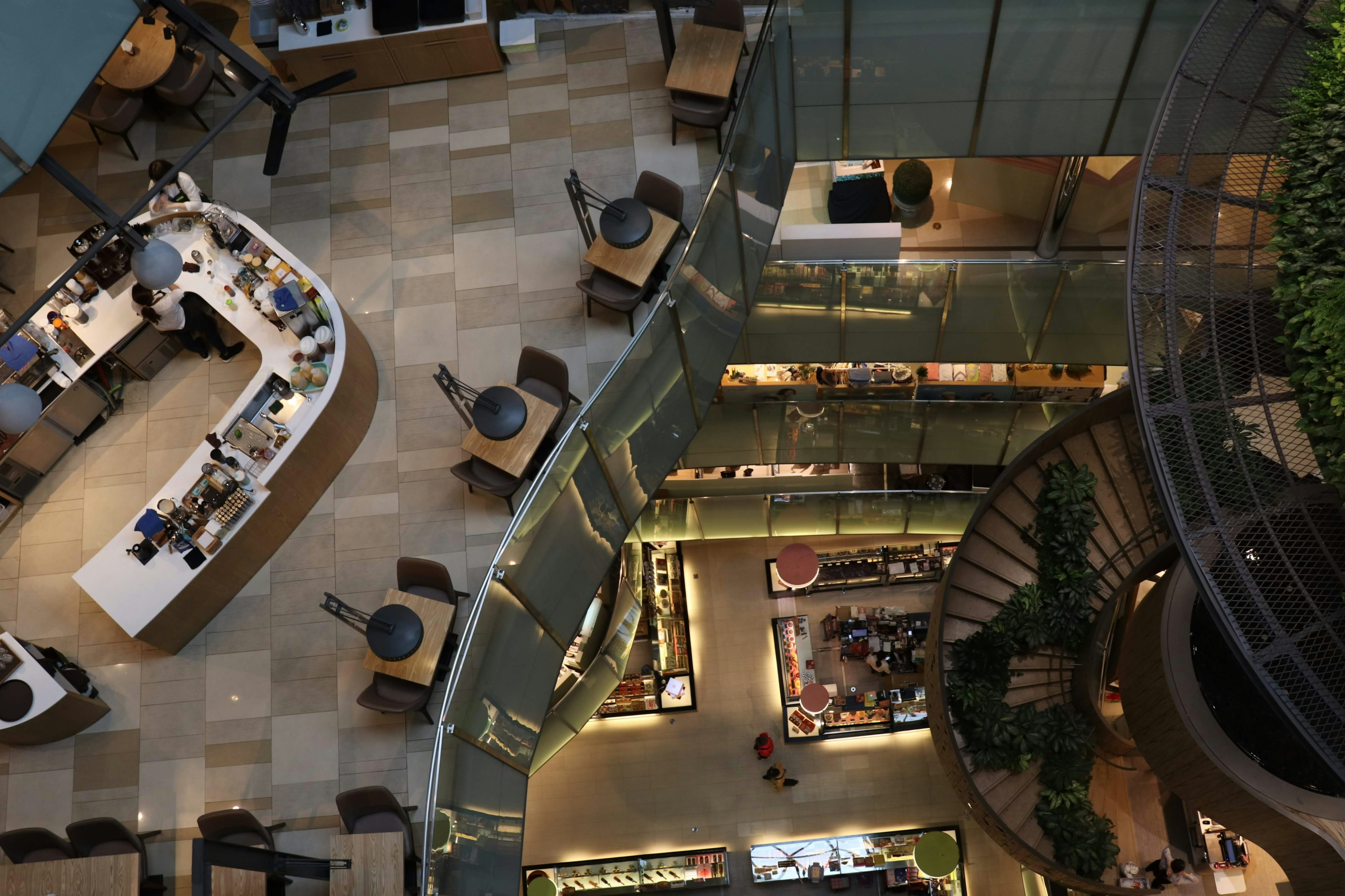 Aerial view of a modern cafe interior featuring stylish furniture and greenery