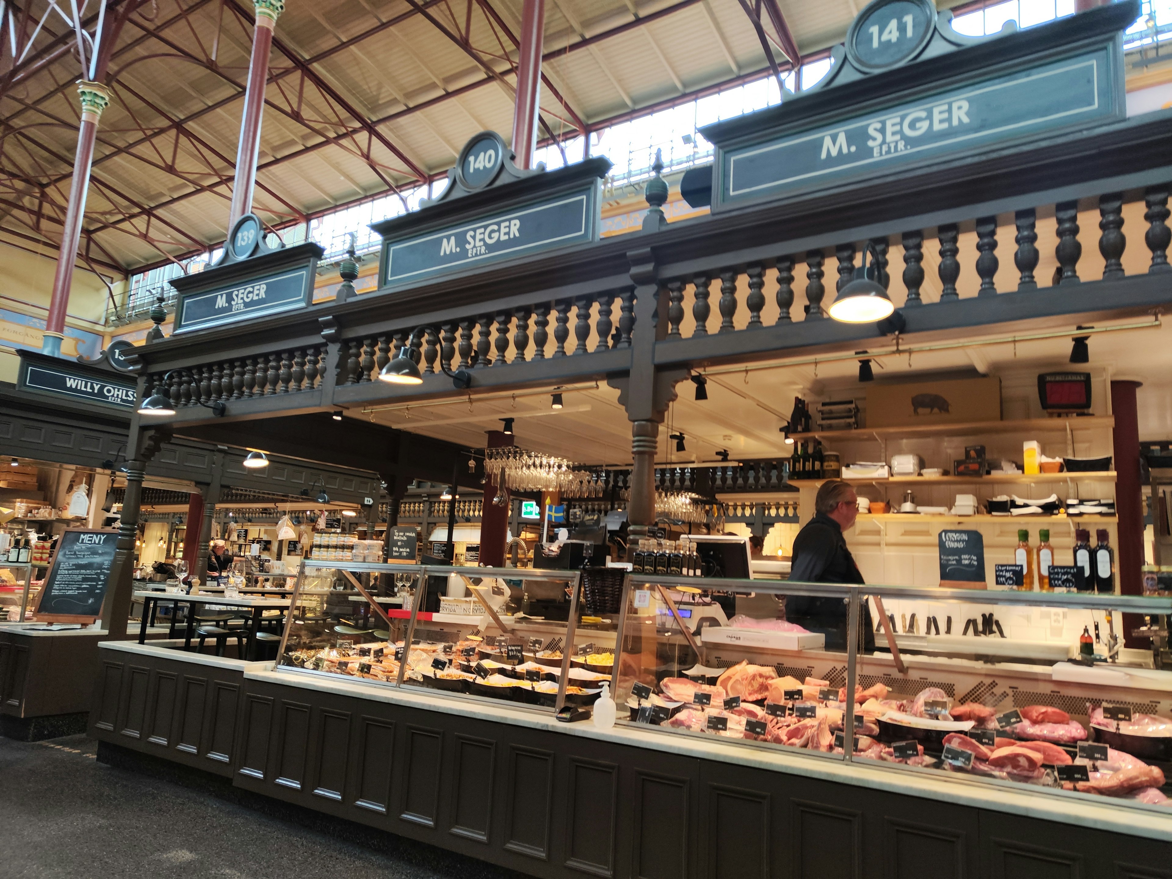 Market butcher counter with fresh meats and ingredients displayed