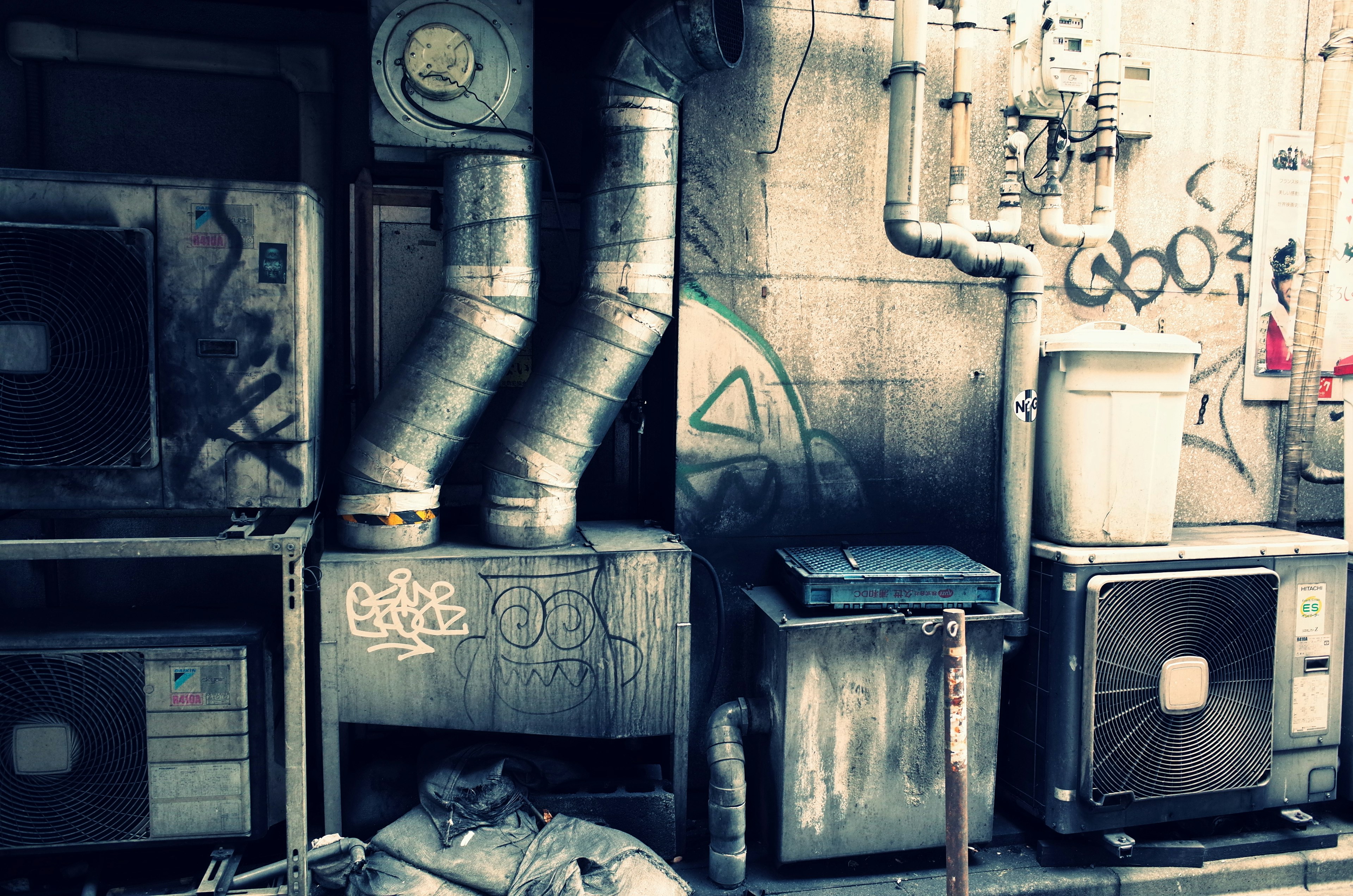 Industrial scene featuring old air conditioning units and pipes