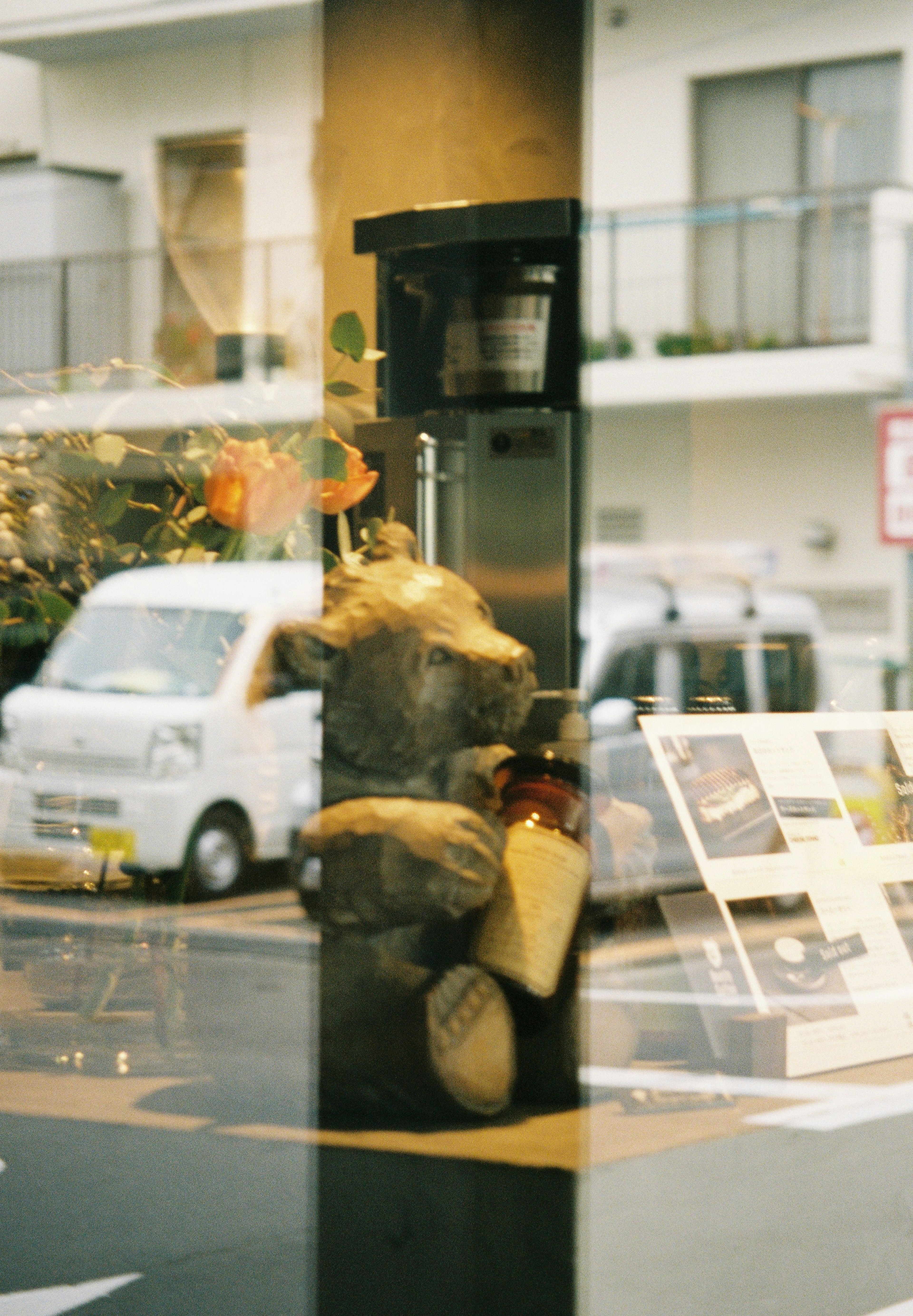 View of the street through glass featuring stacked garbage bags