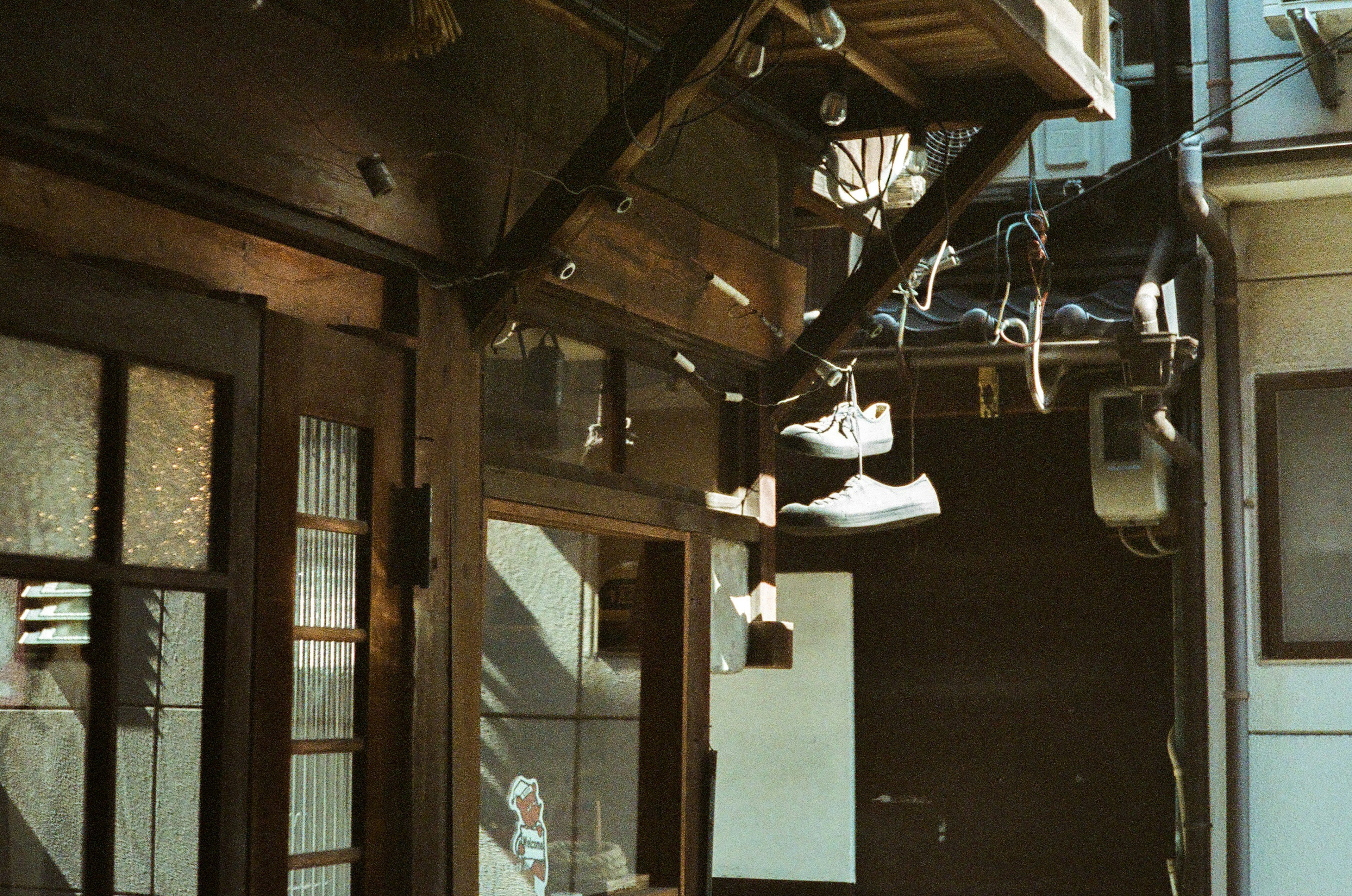 Exterior of an old building with shoes hanging