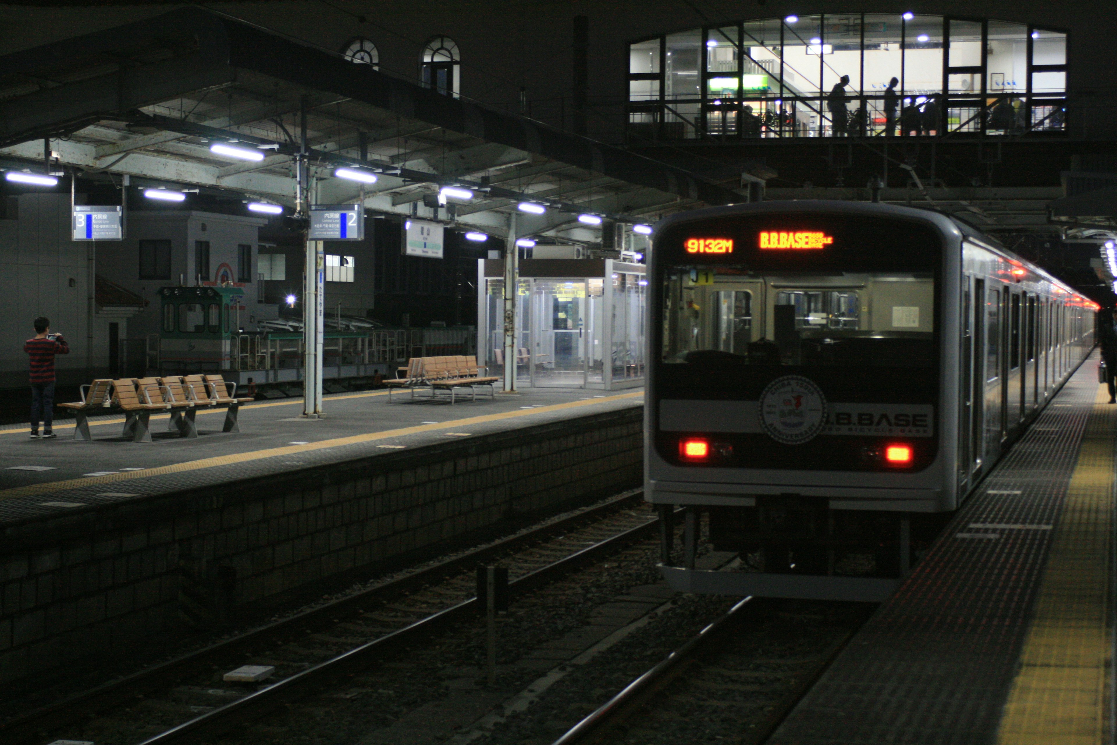 Train stopped at night station with illuminated platform