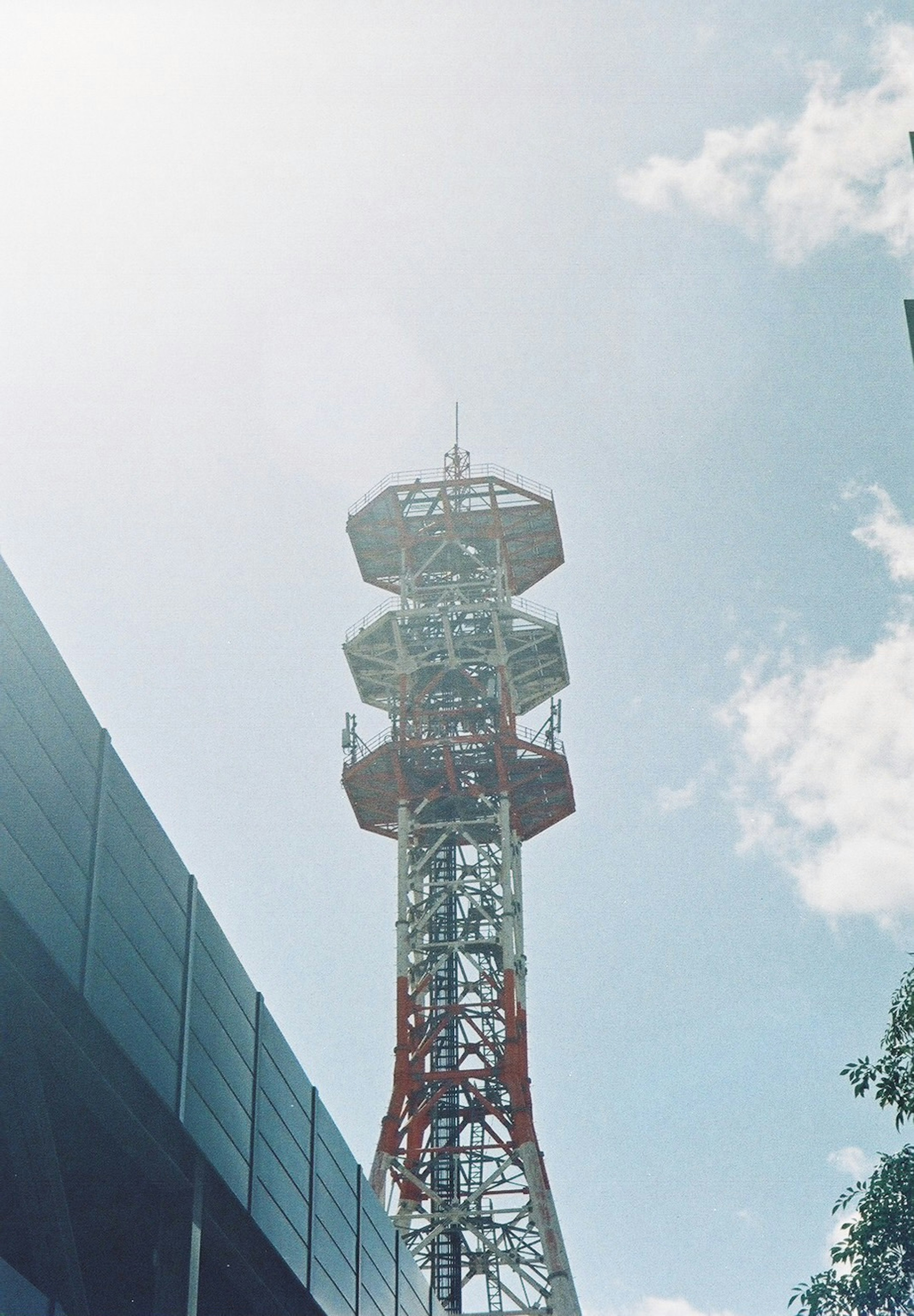 Photo of a communication tower towering under a blue sky