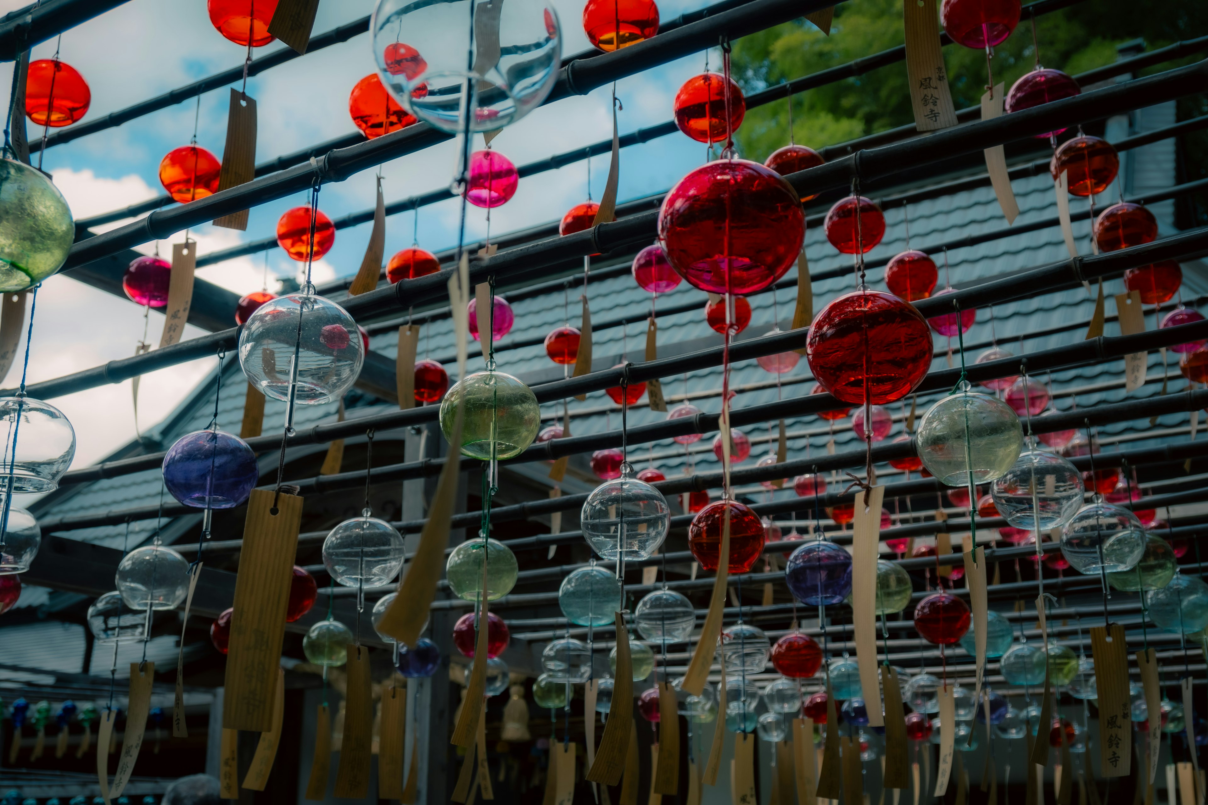 Colorful wind chimes hanging in an outdoor setting