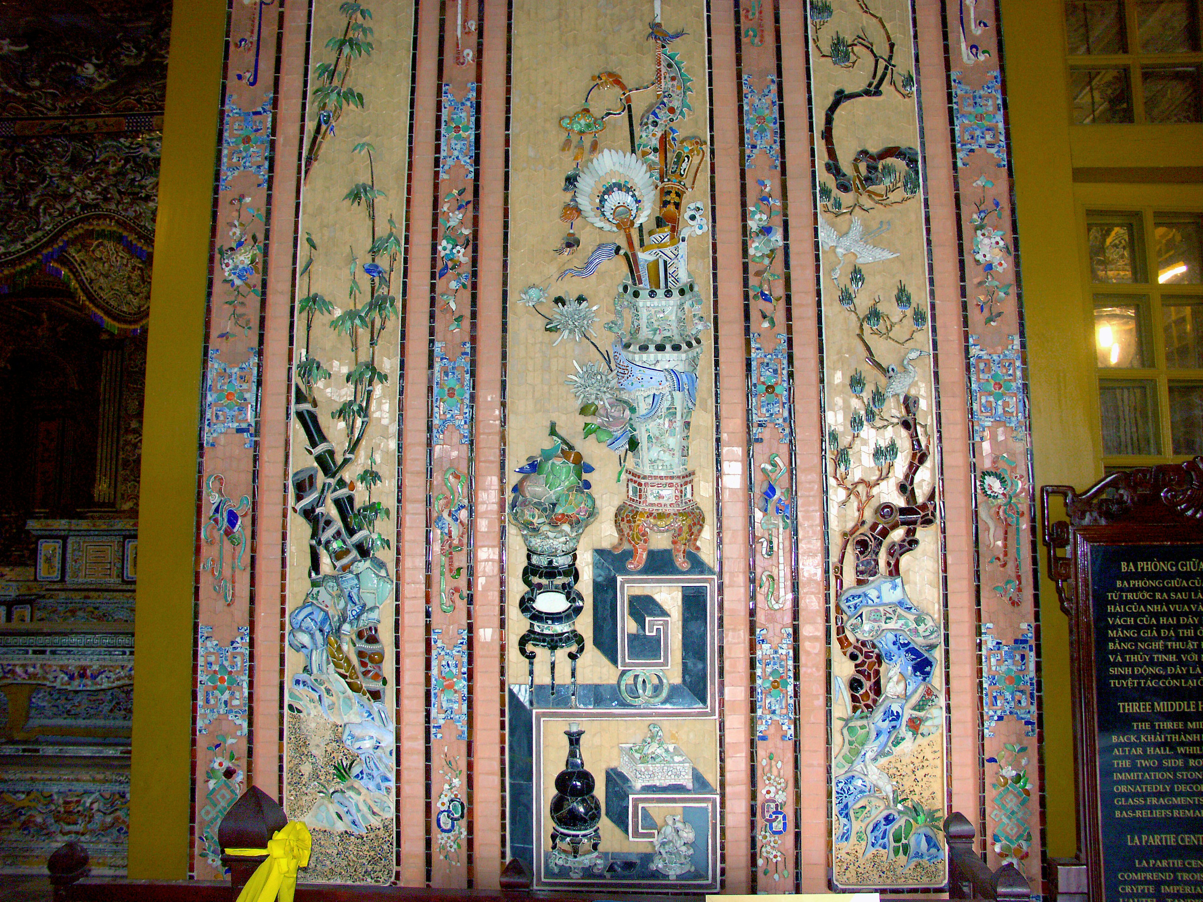 Ornately decorated wall featuring traditional ceramics and floral designs