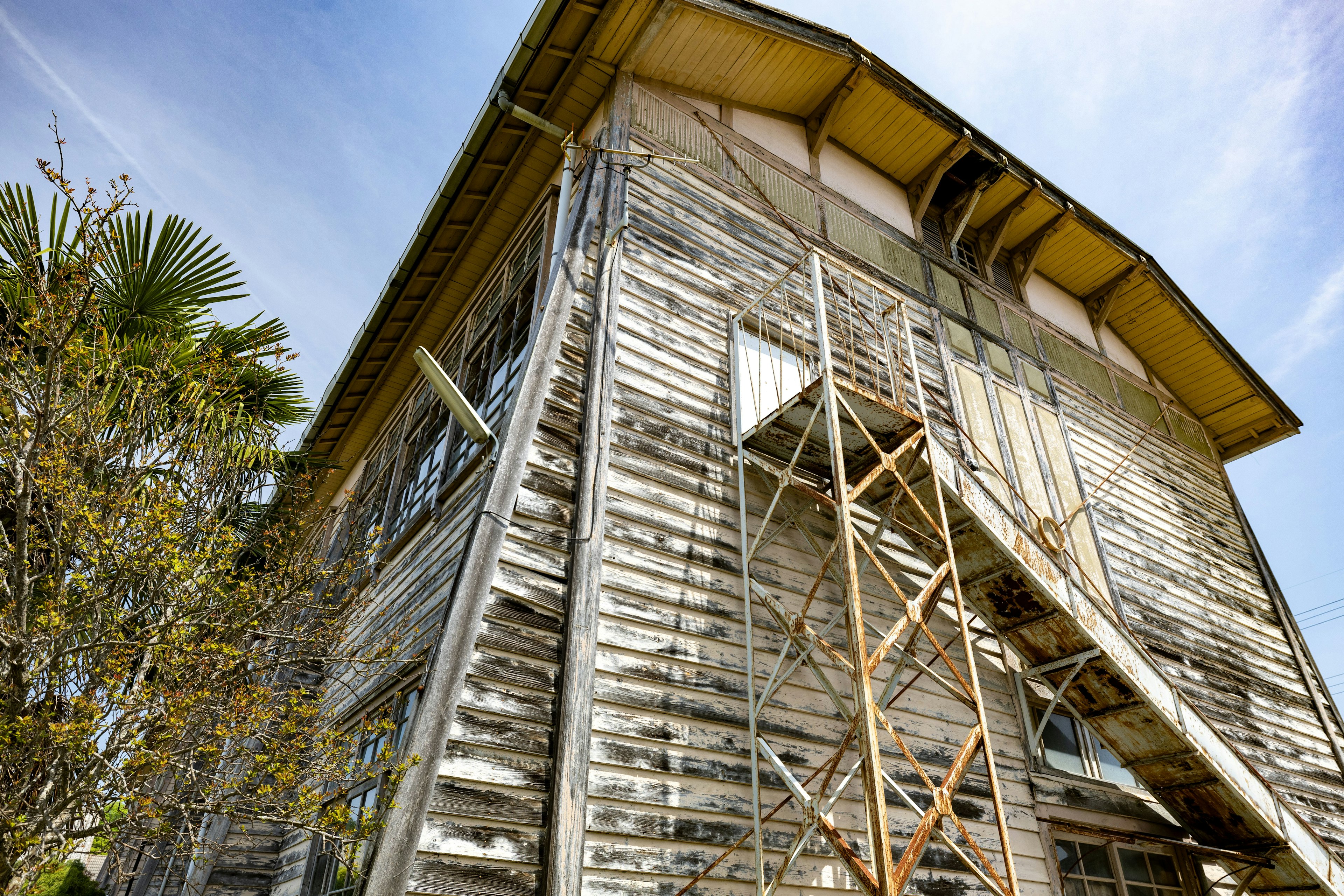 Exterior of an old wooden building with scaffolding for restoration