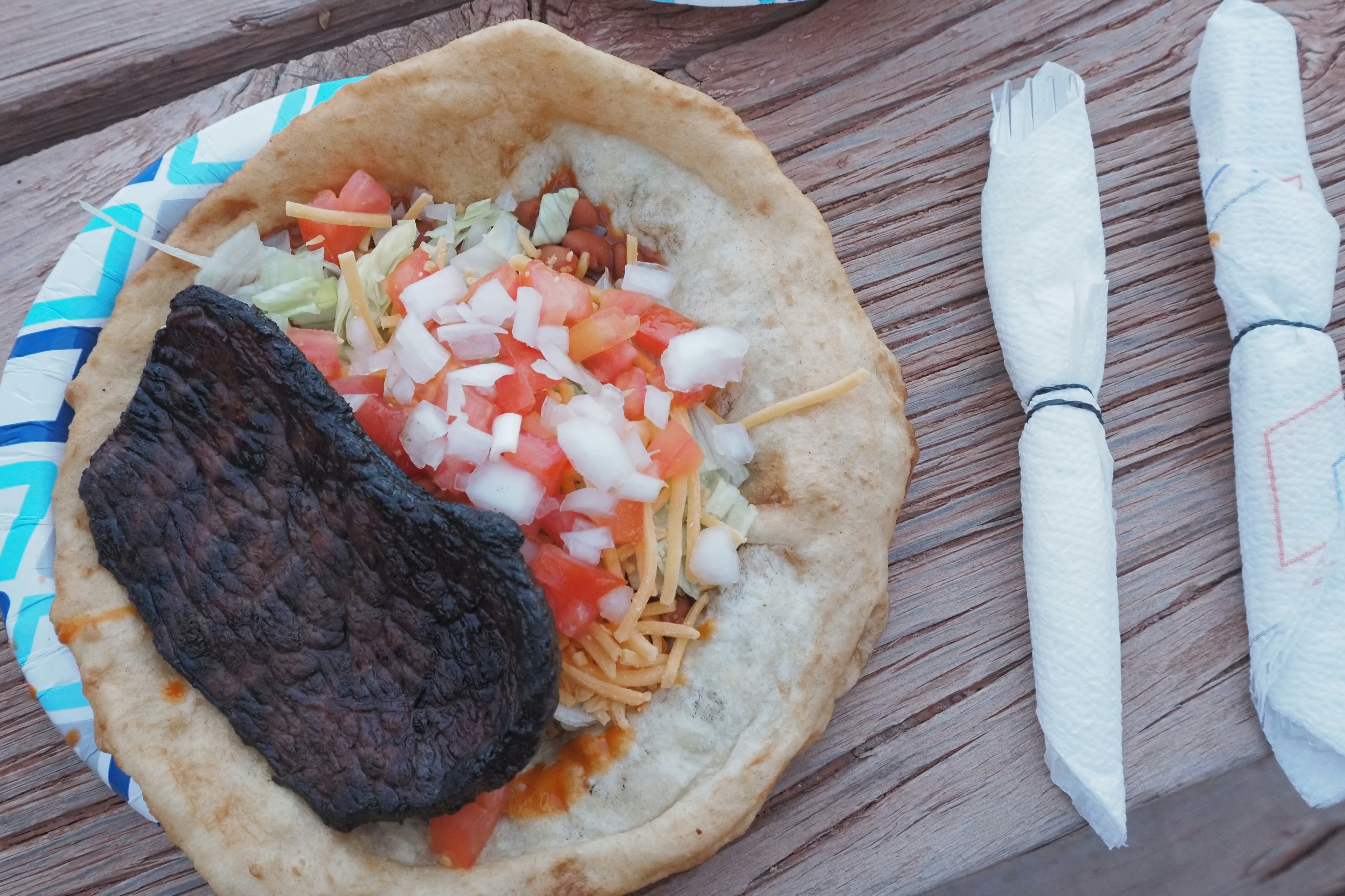 A tortilla filled with meat and fresh vegetables