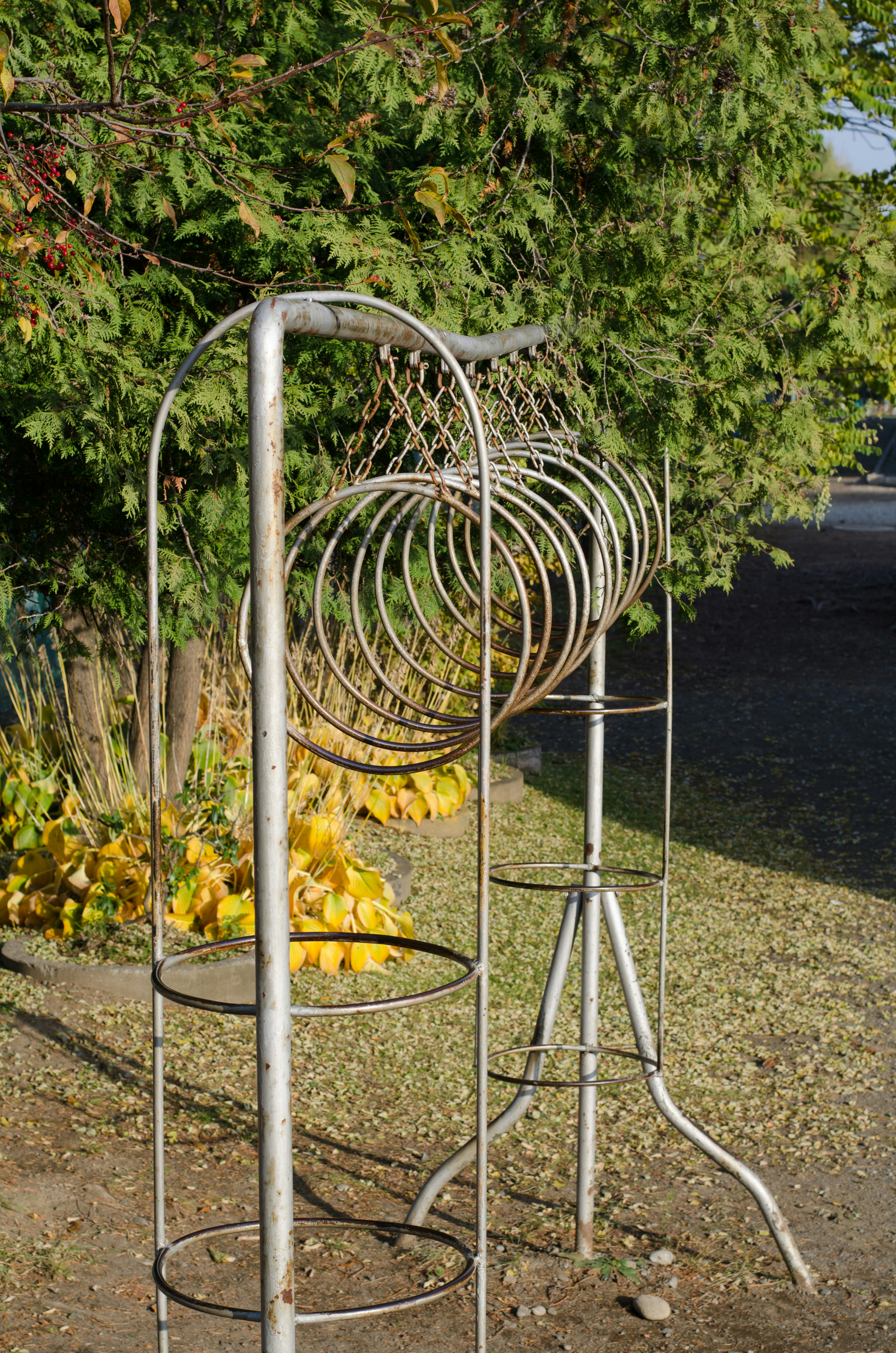 Metal ring stand with green trees in the background