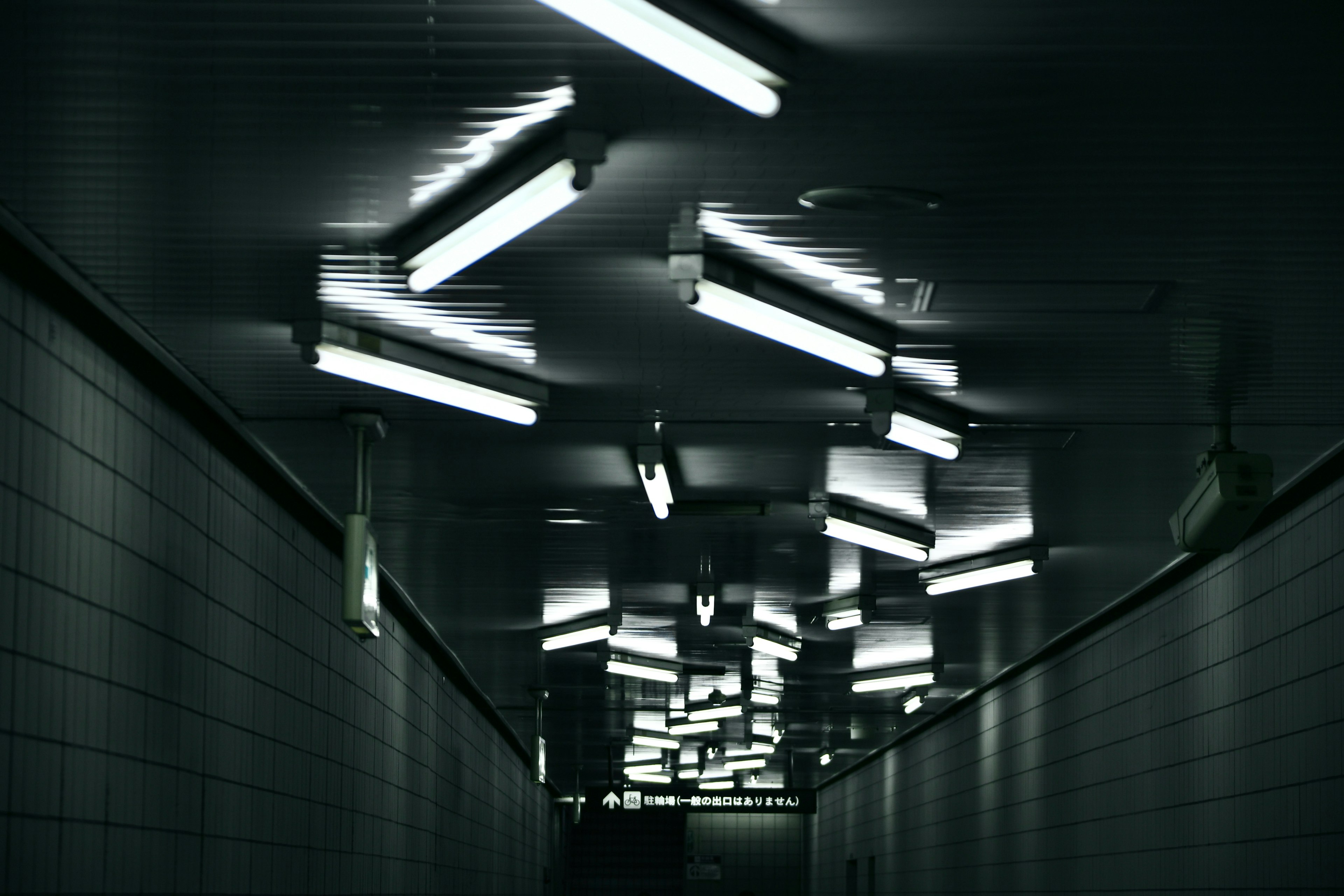 Dimly lit corridor with bright fluorescent lights