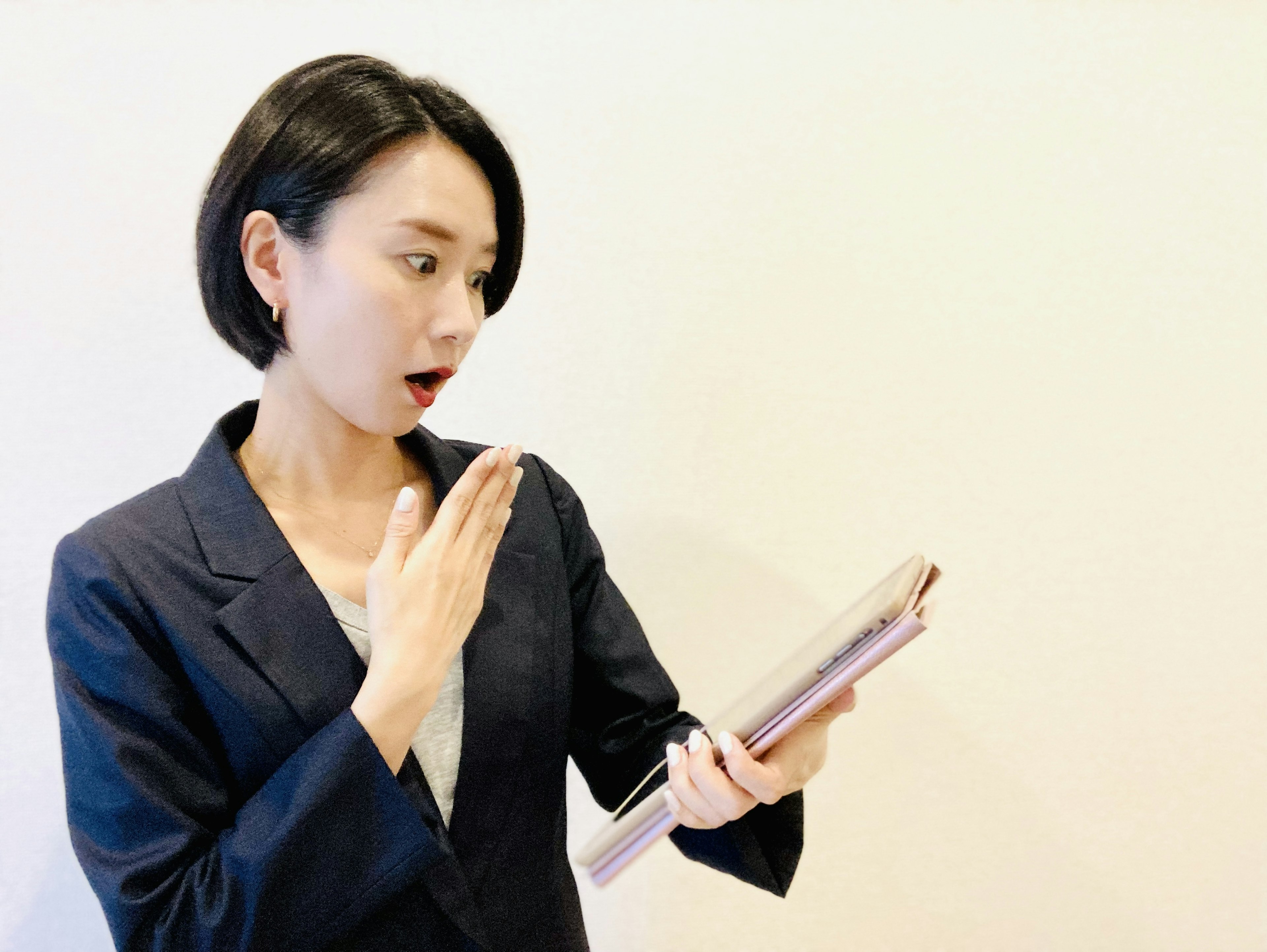 A surprised woman holding a document