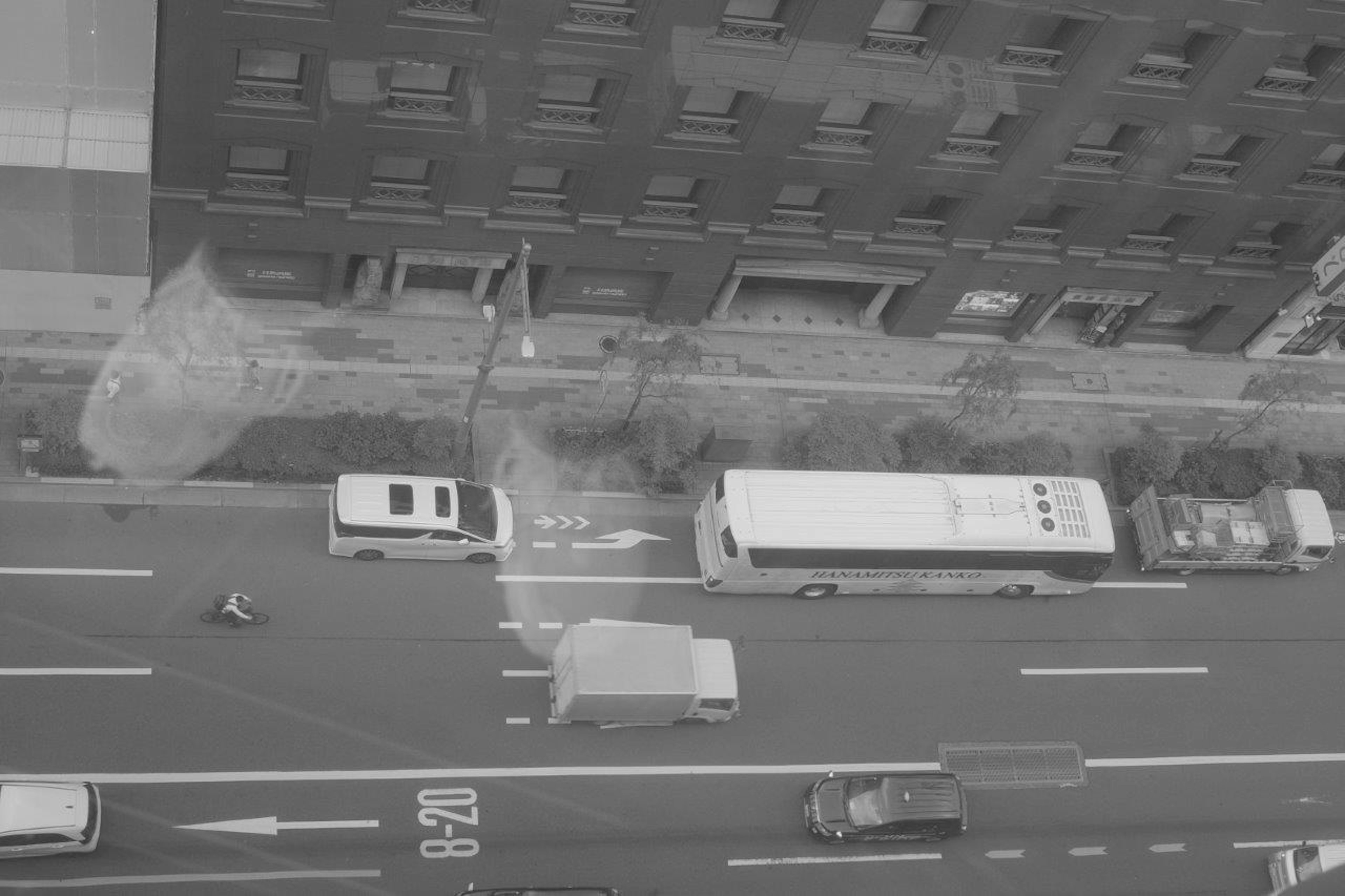 Aerial view of parked vehicles on a road next to a building