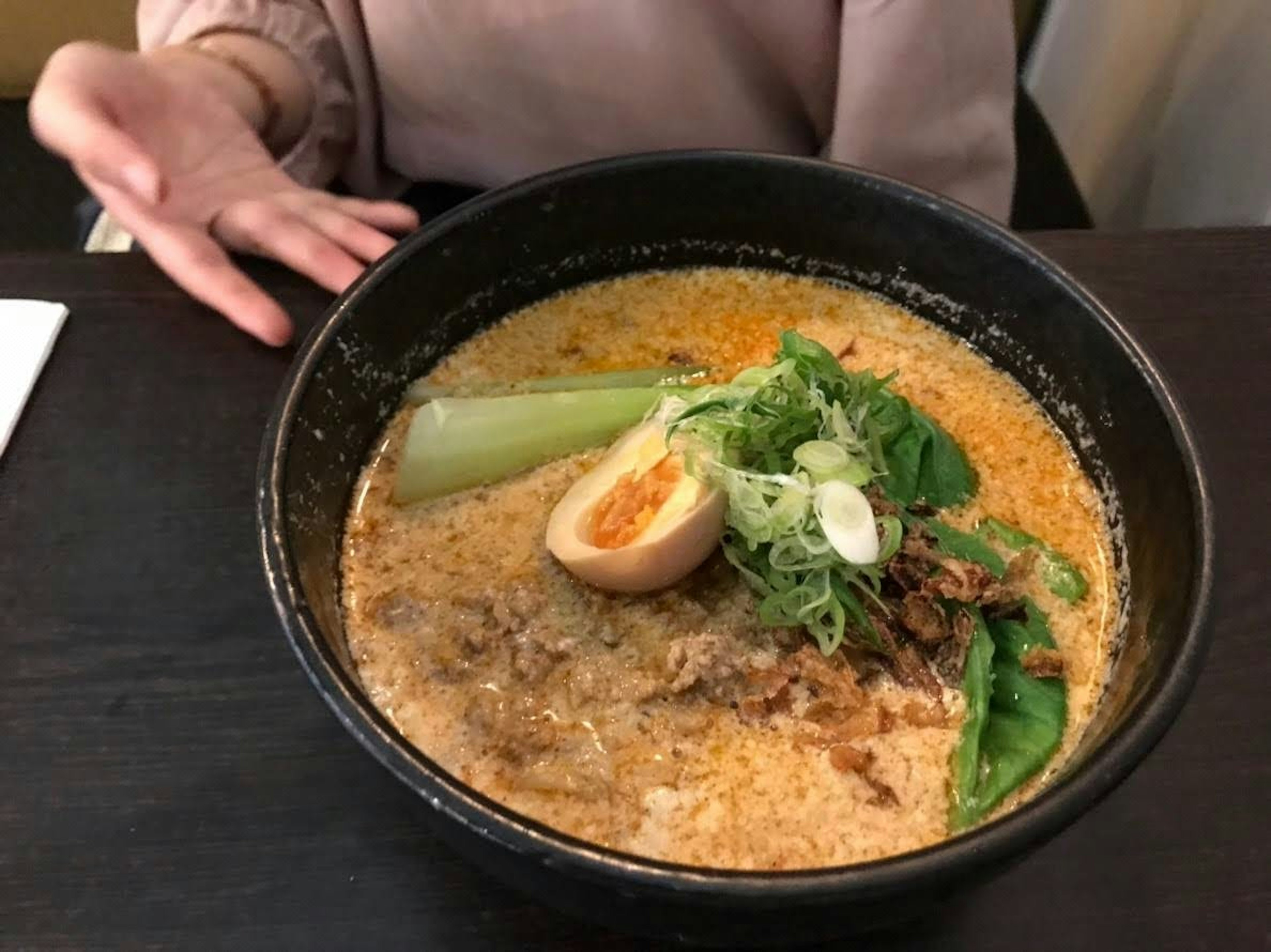 Delicious ramen with creamy broth topped with soft-boiled egg and green onions