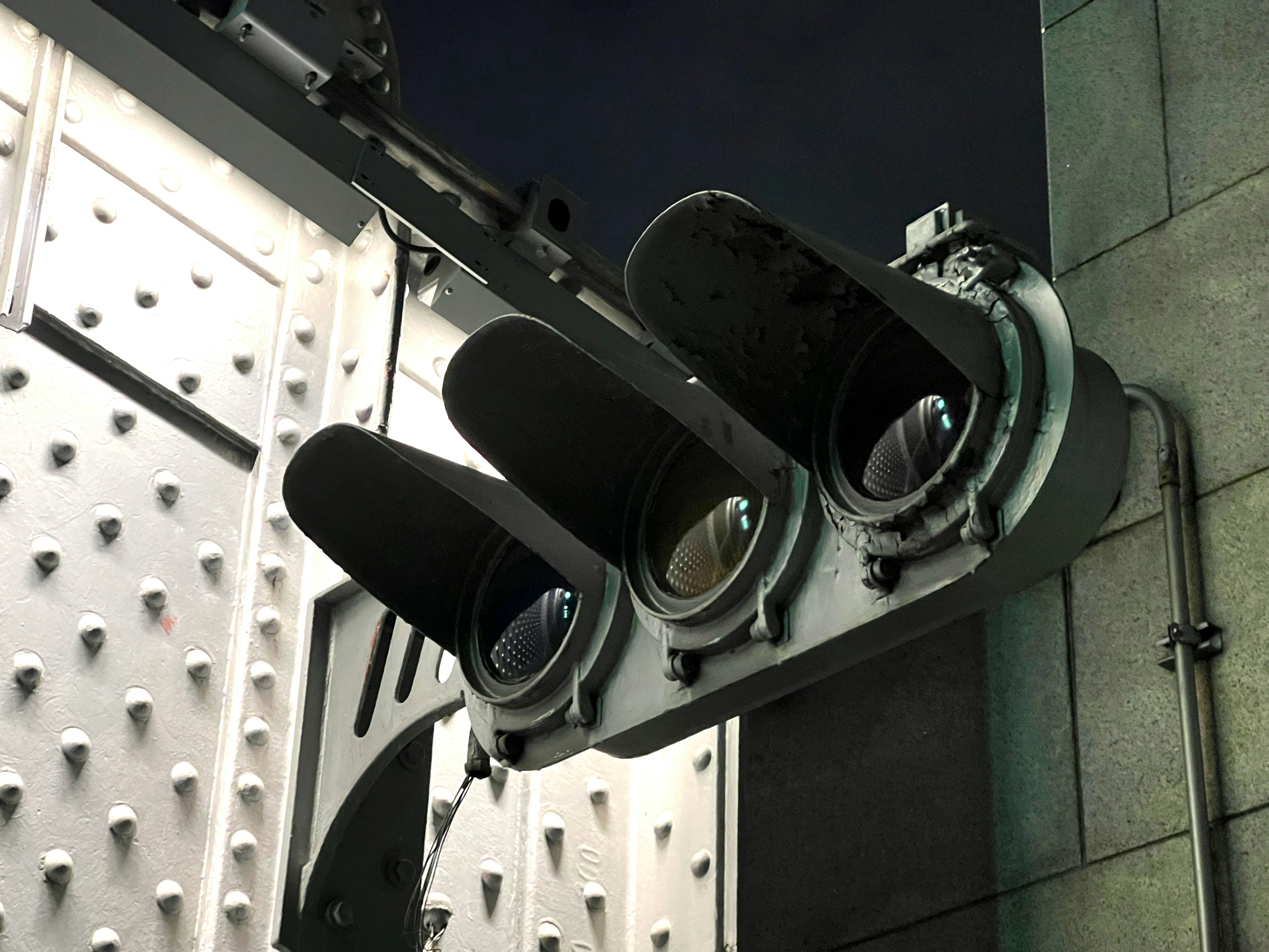 Close-up image of a traffic light featuring three black signals