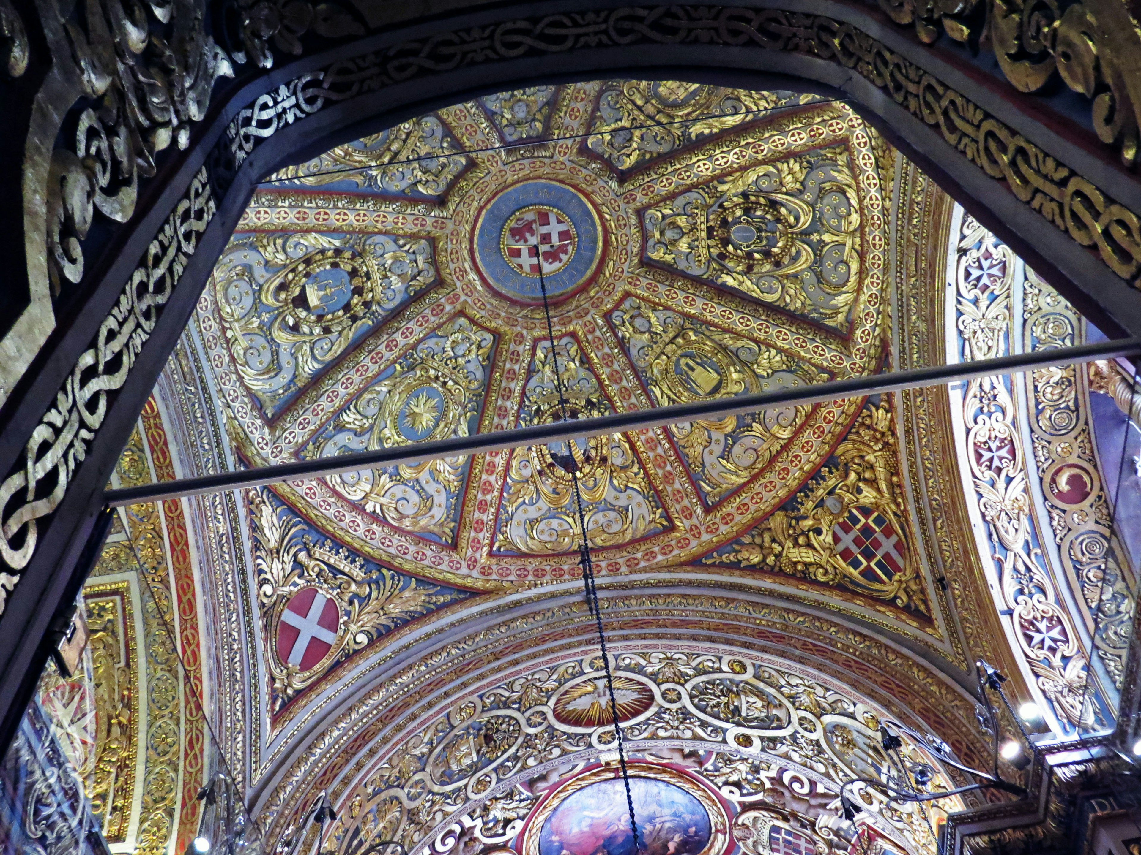 Intricate decorated ceiling arch featuring golden patterns and geometric designs