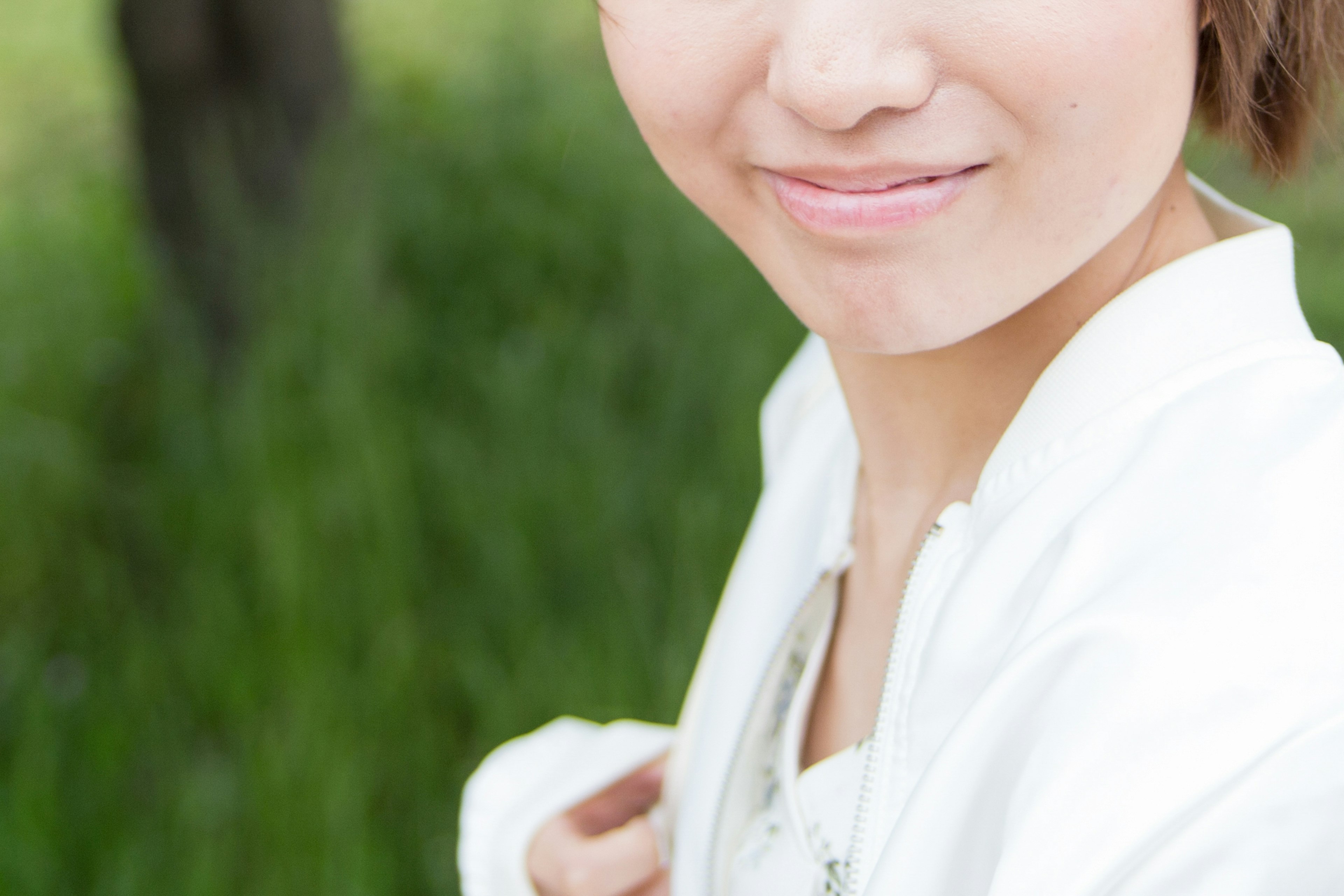 Young woman smiling in a green background photo