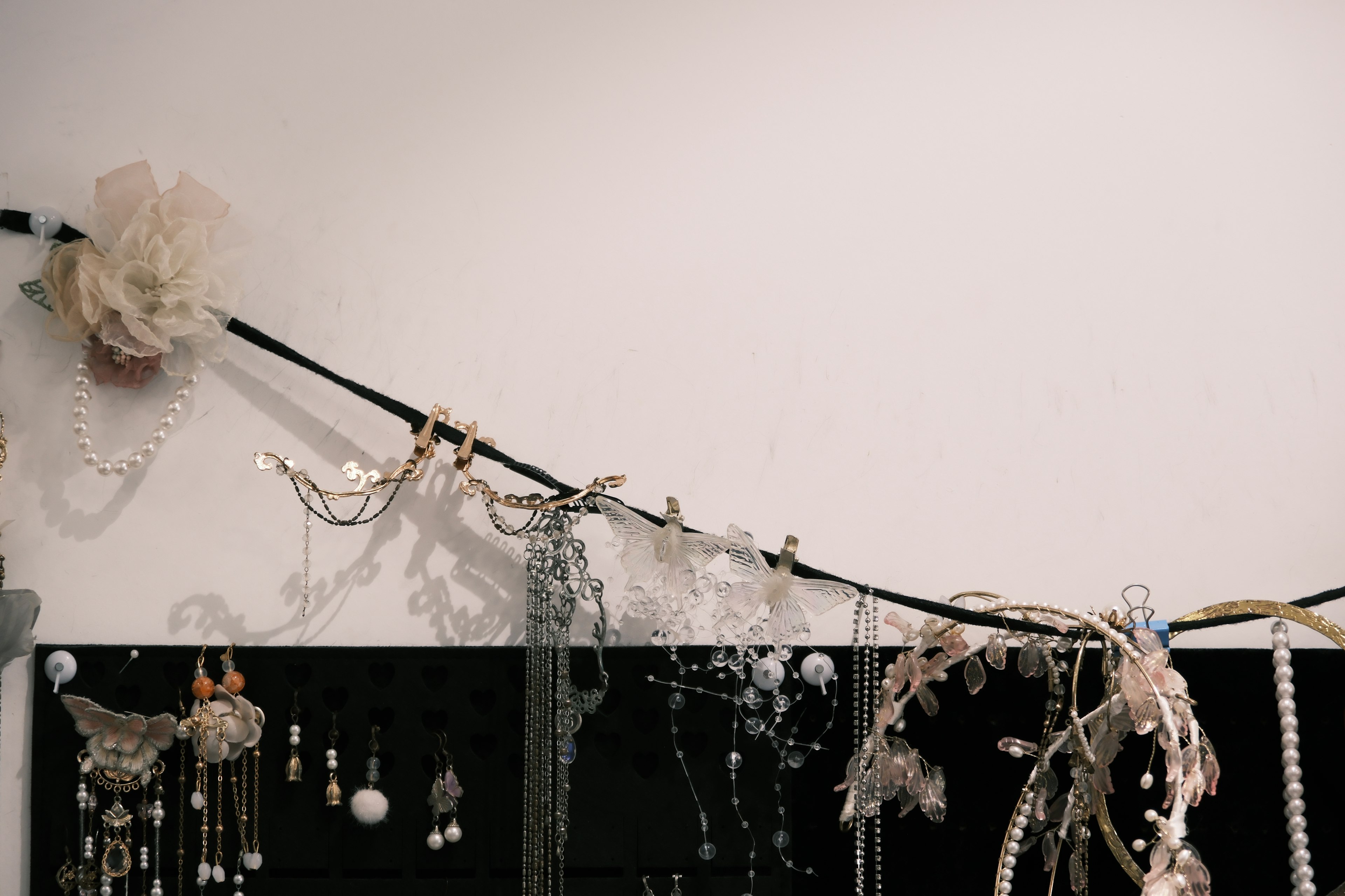 Jewelry display with beads and accessories hanging on a wall