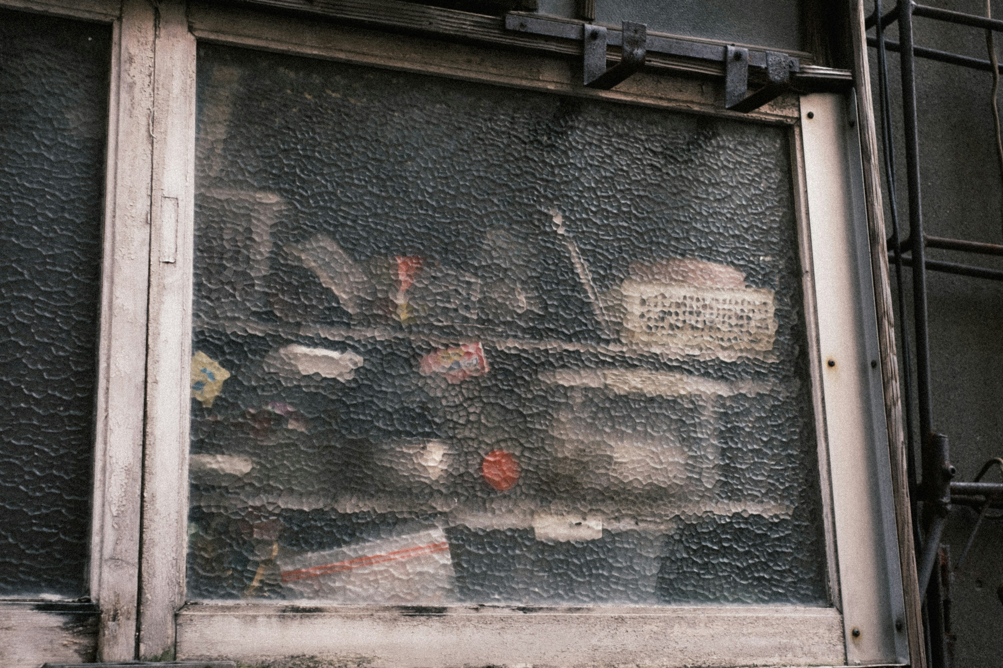 Cluttered display of items seen through a frosted window