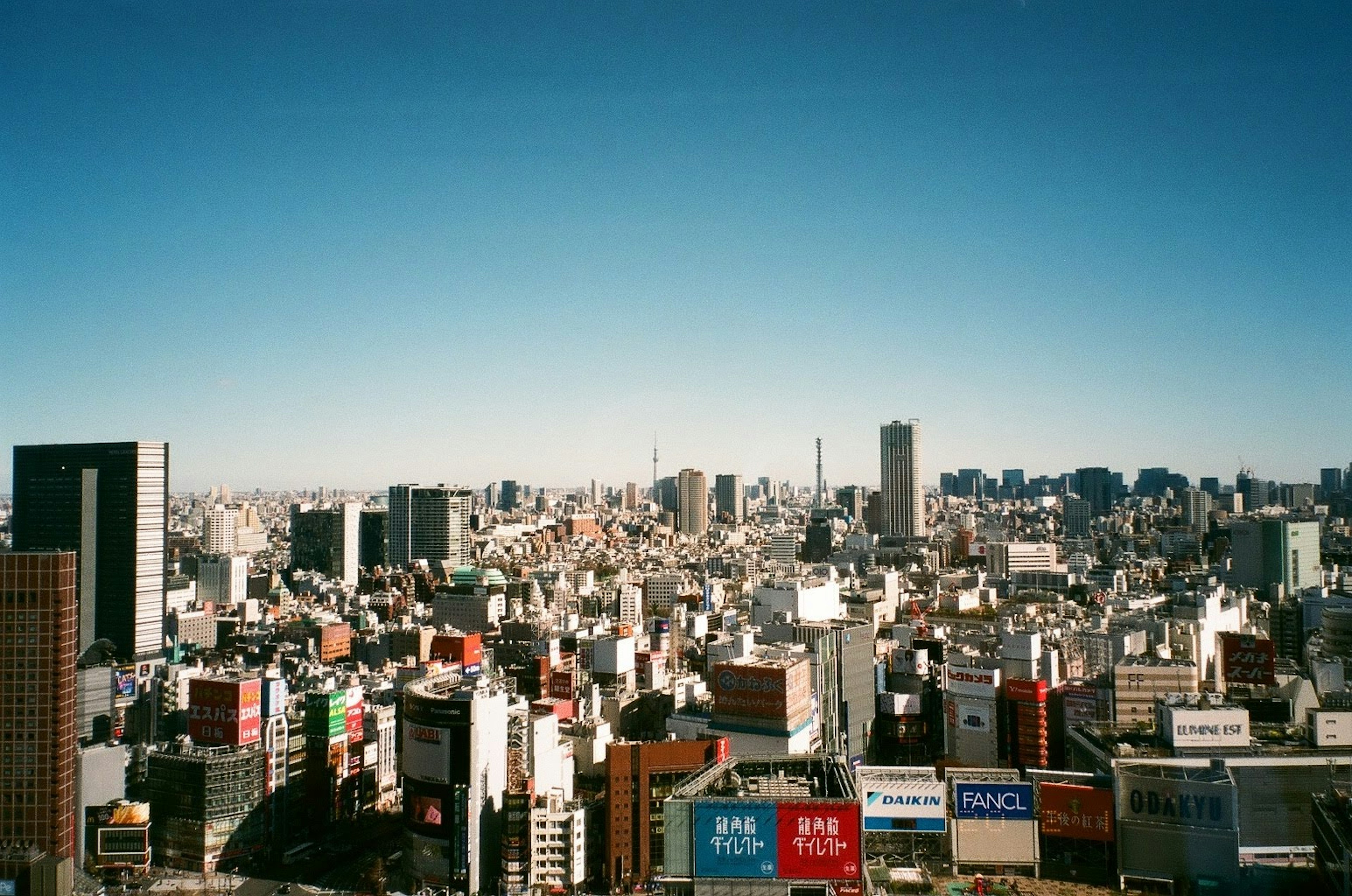 Tokyo cityscape with blue sky buildings and billboards