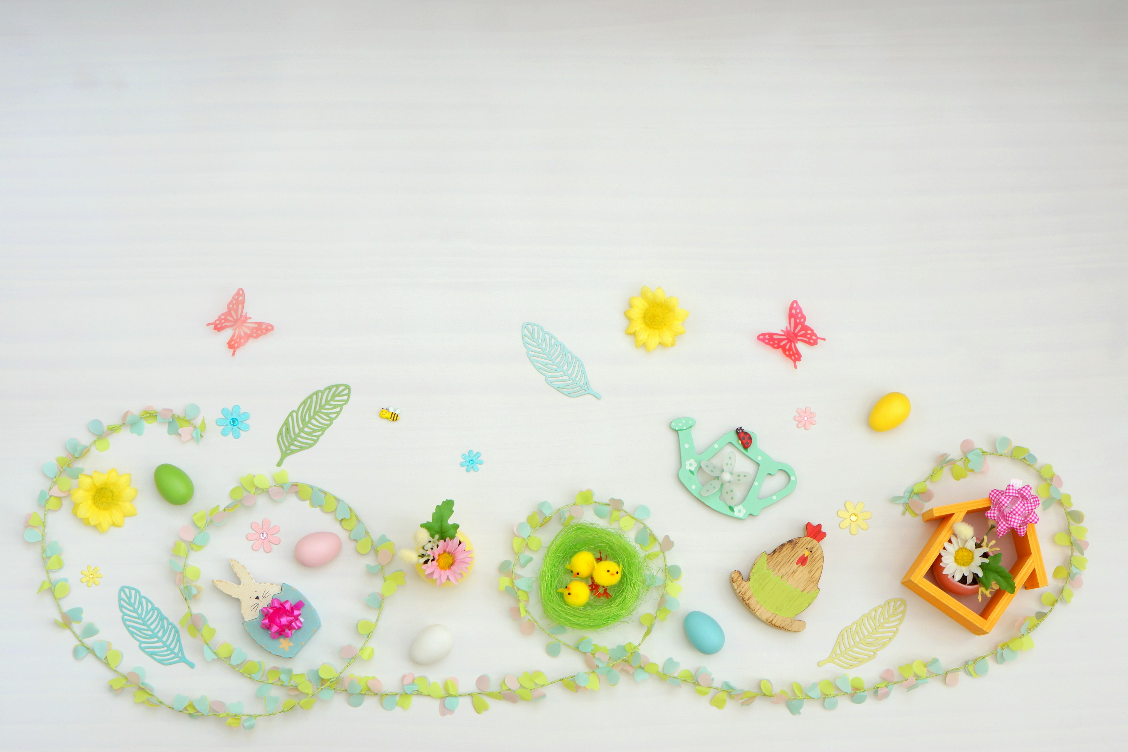 Colorful spring decorations featuring small flowers, eggs, and butterflies scattered around