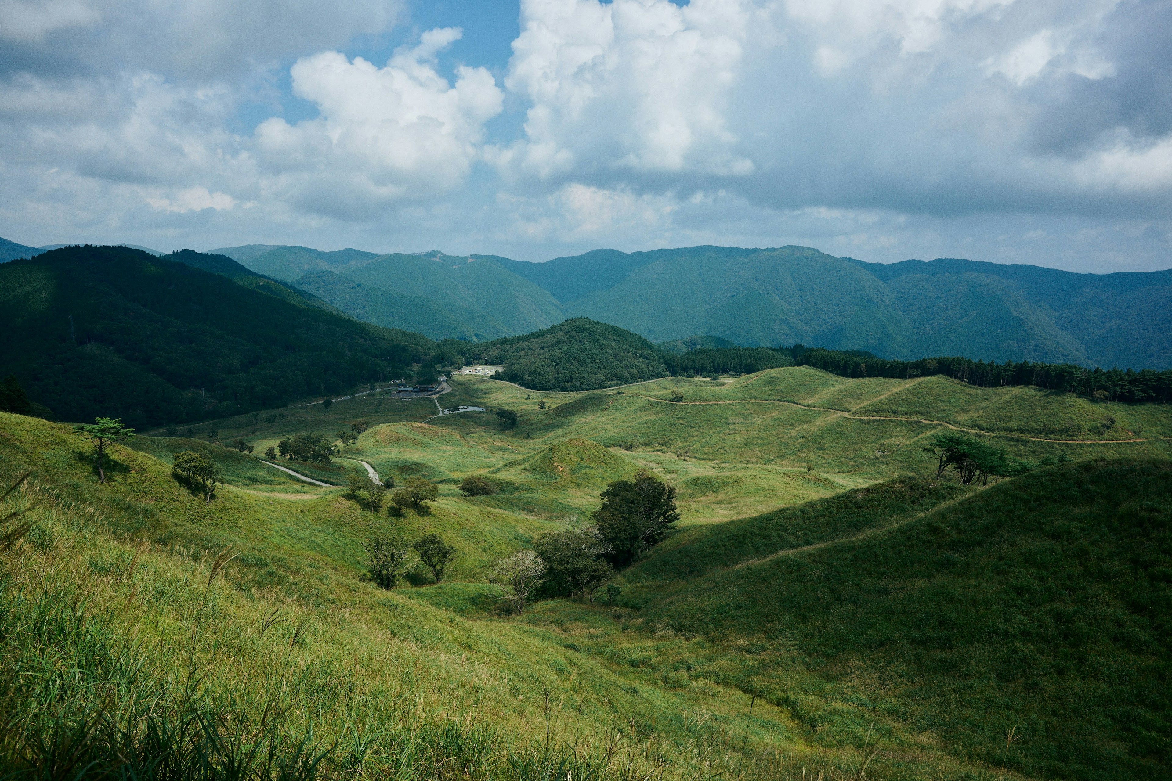 Lush green hills and a blue sky landscape