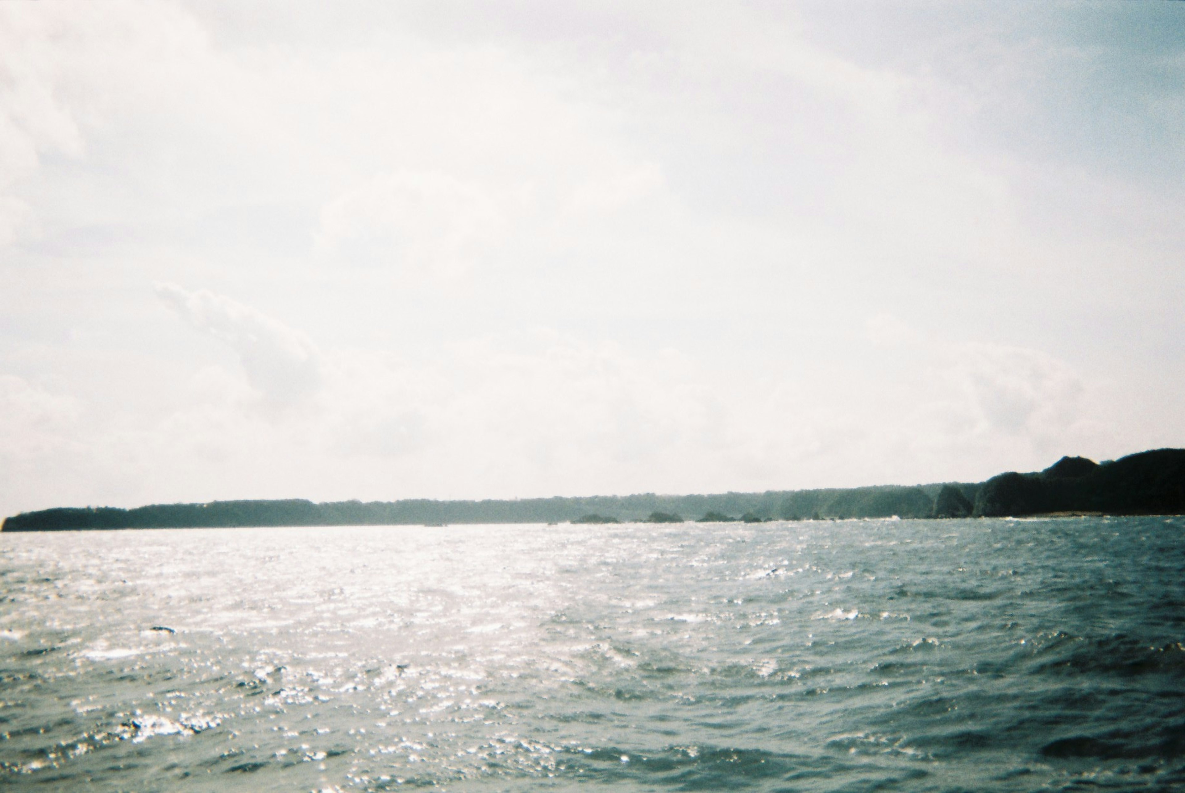 Scenic view of shimmering ocean waters under a bright sky