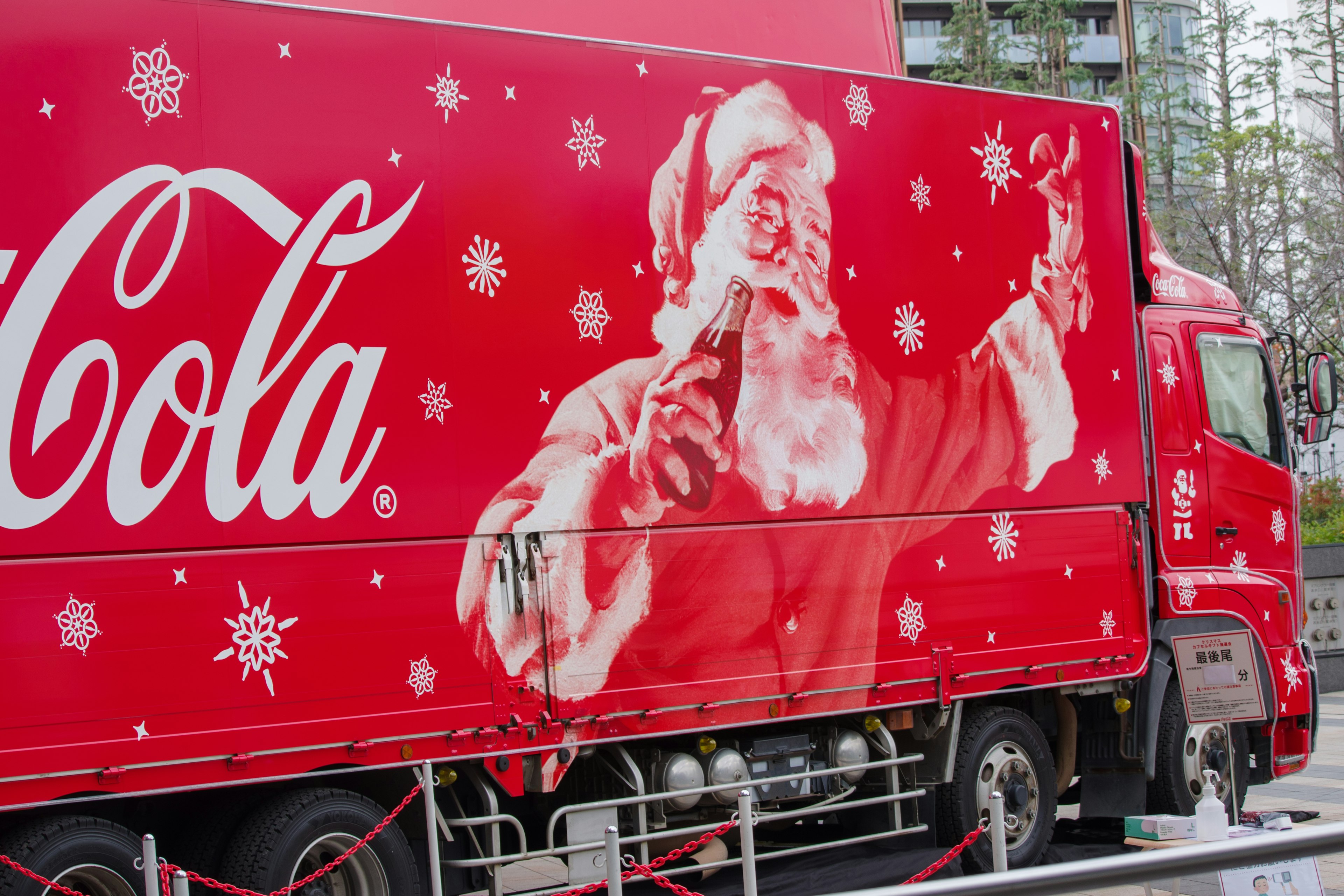 Red Coca-Cola truck featuring Santa Claus with snowflakes