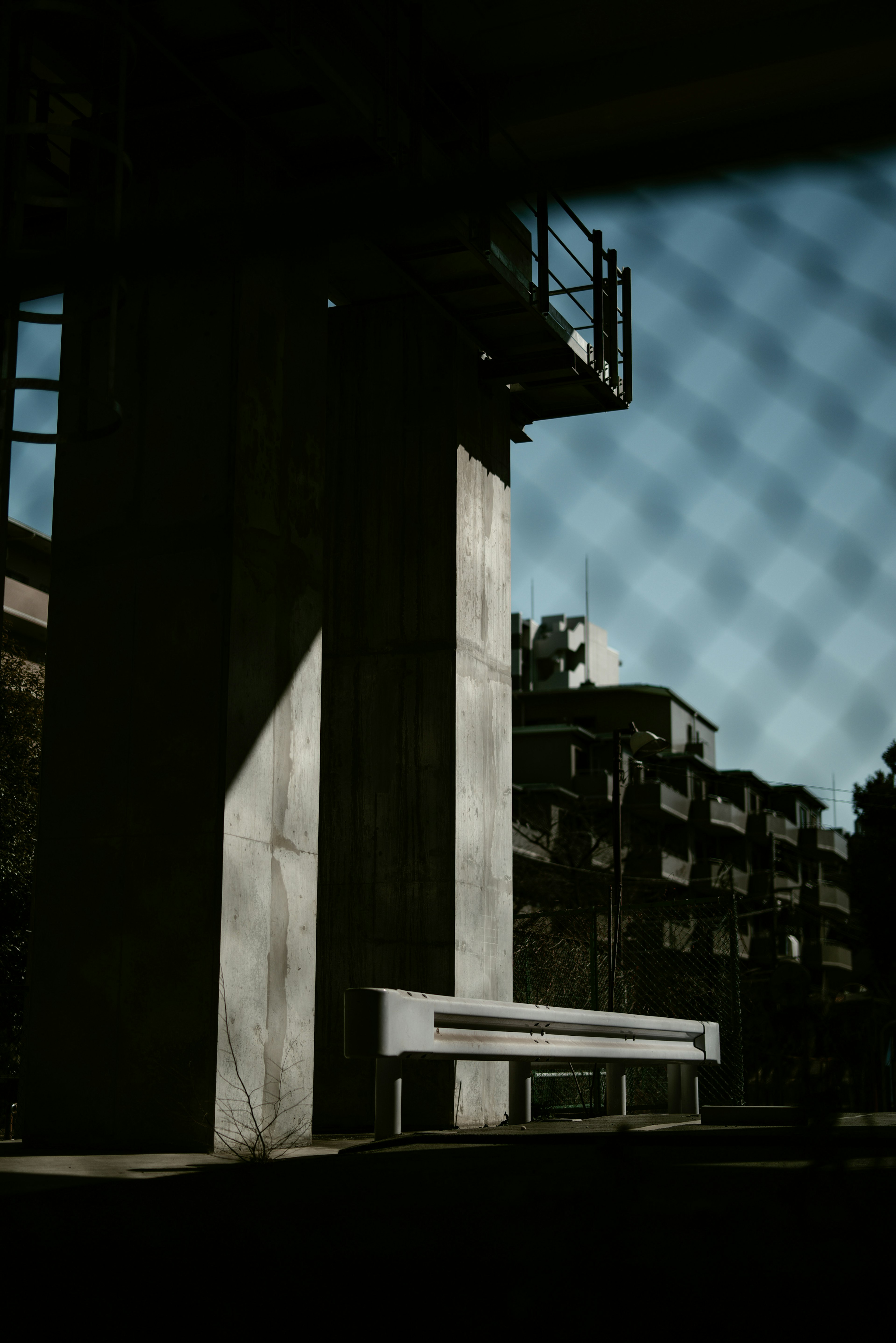 Urban scene featuring a concrete pillar and a bench