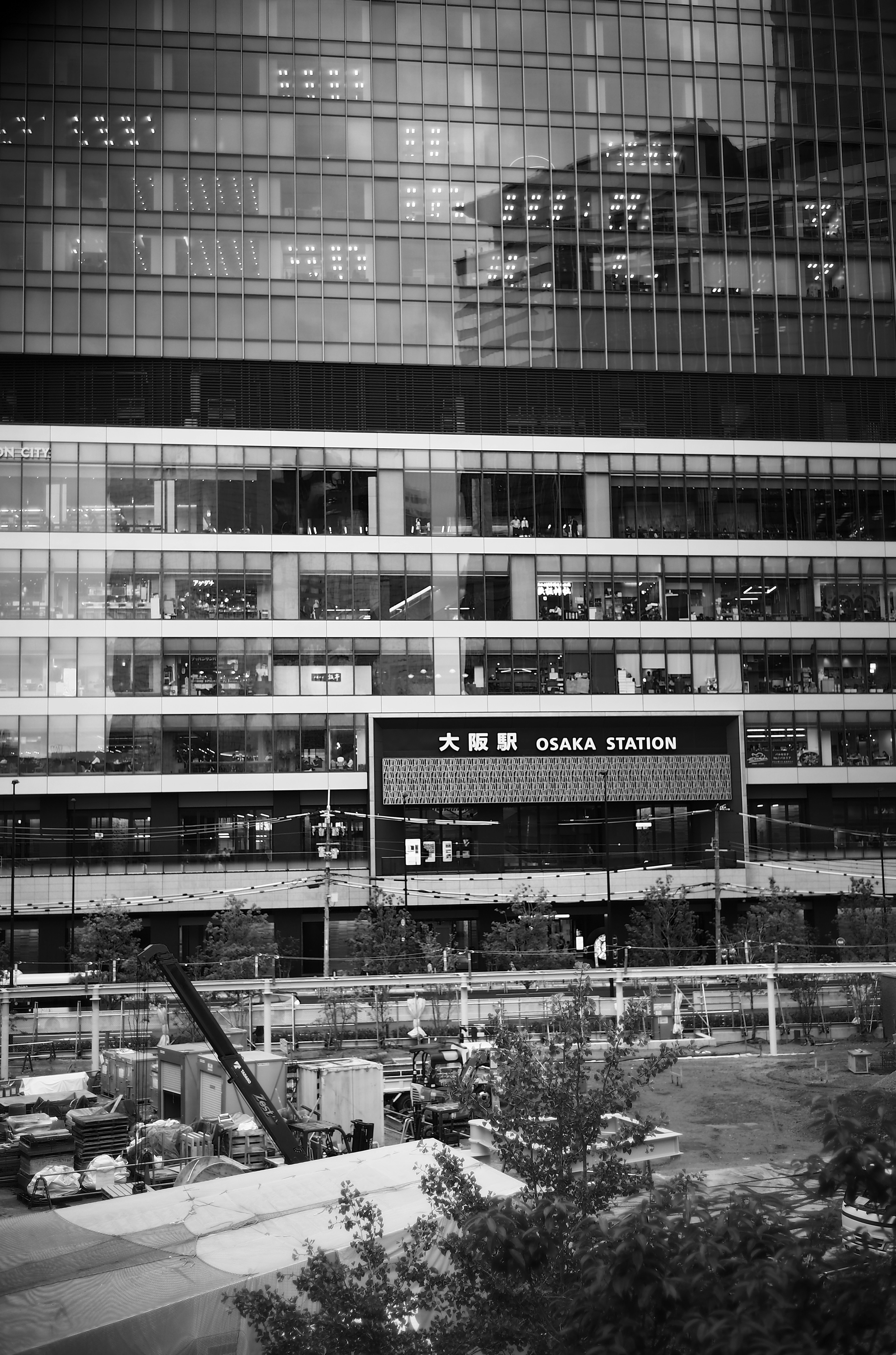 Black and white exterior of a building featuring a bus terminal sign