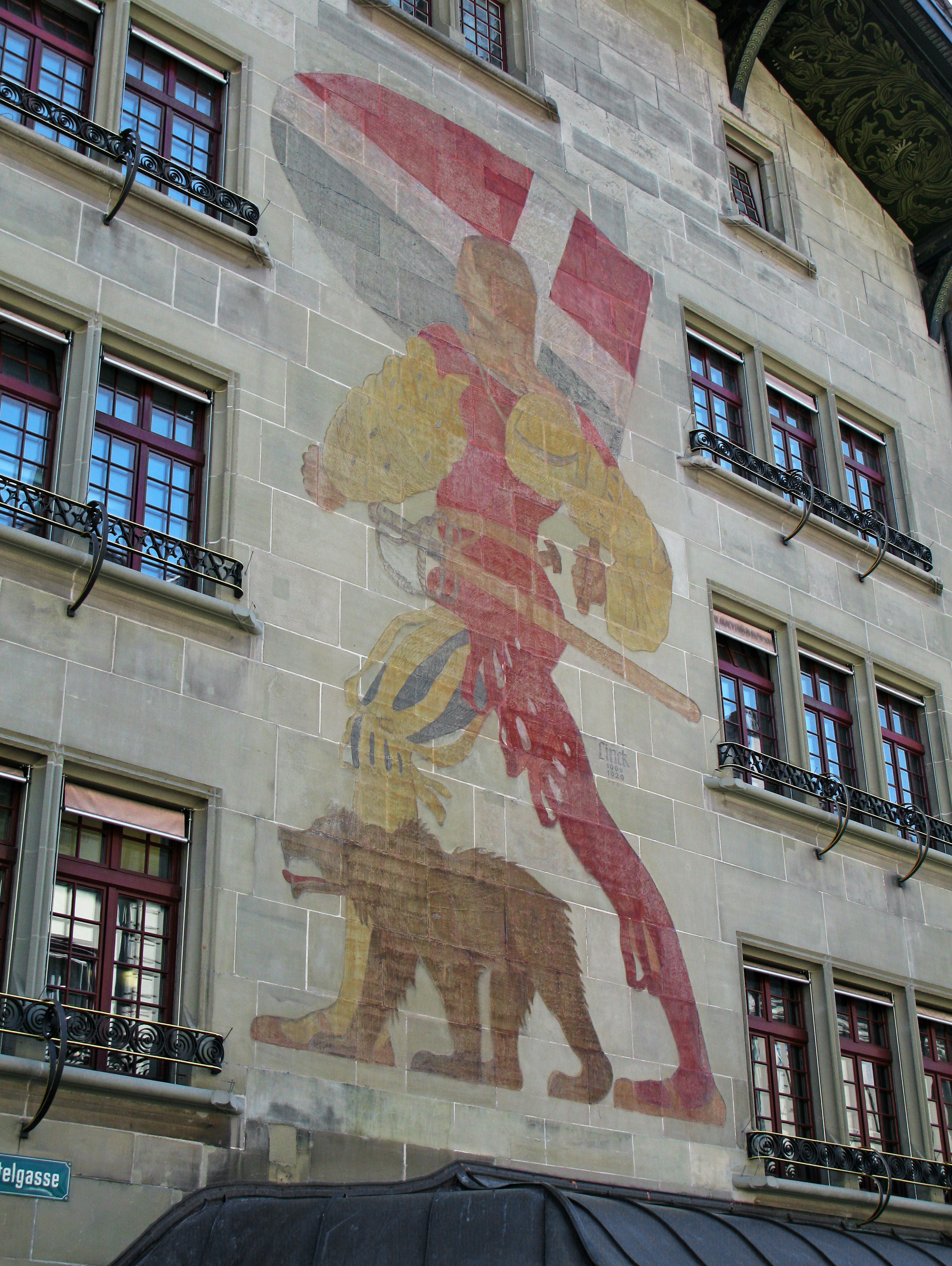 Mural of Saint George with a bear on a building facade