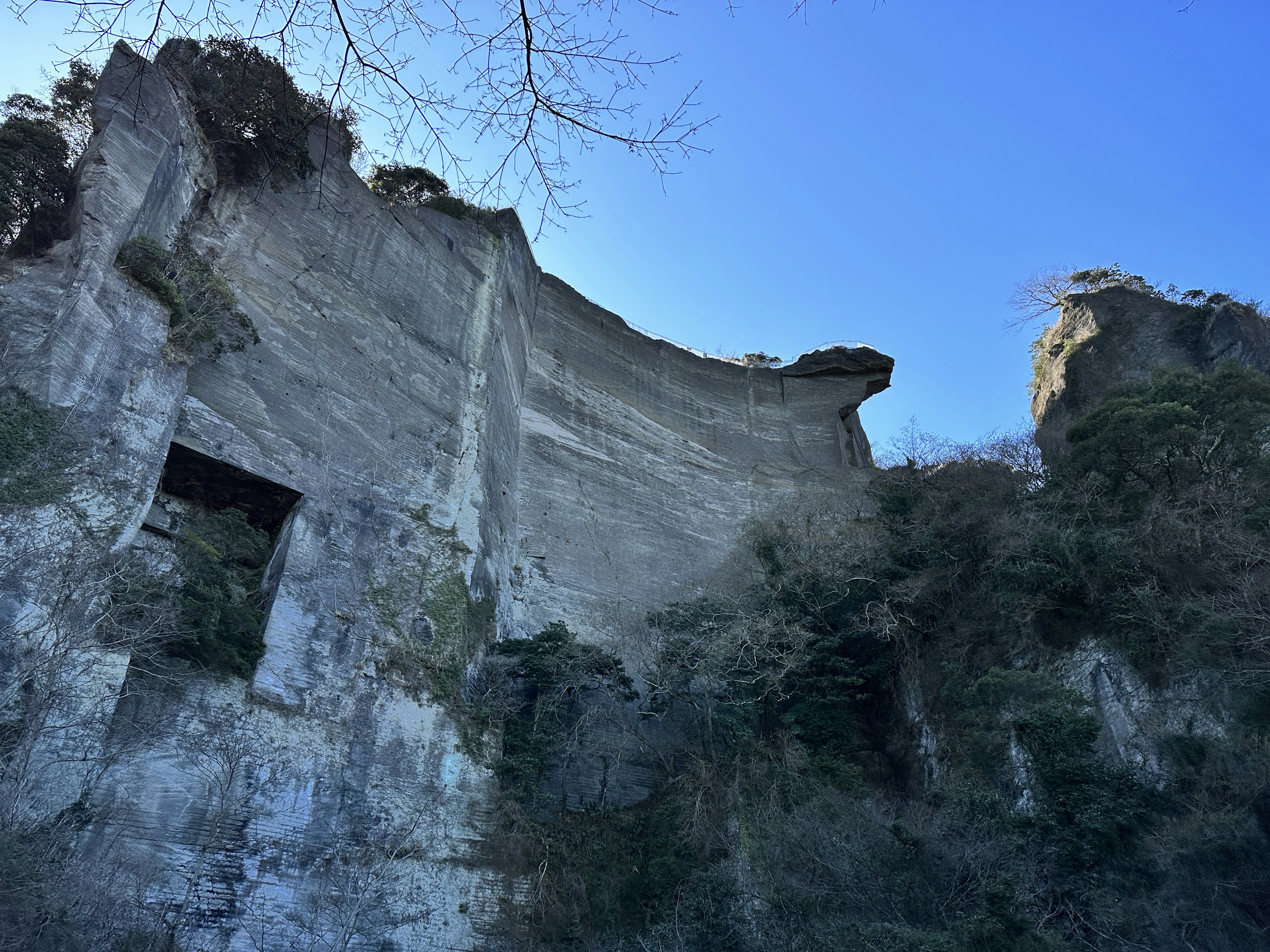 Crumbled concrete cliff against a clear blue sky