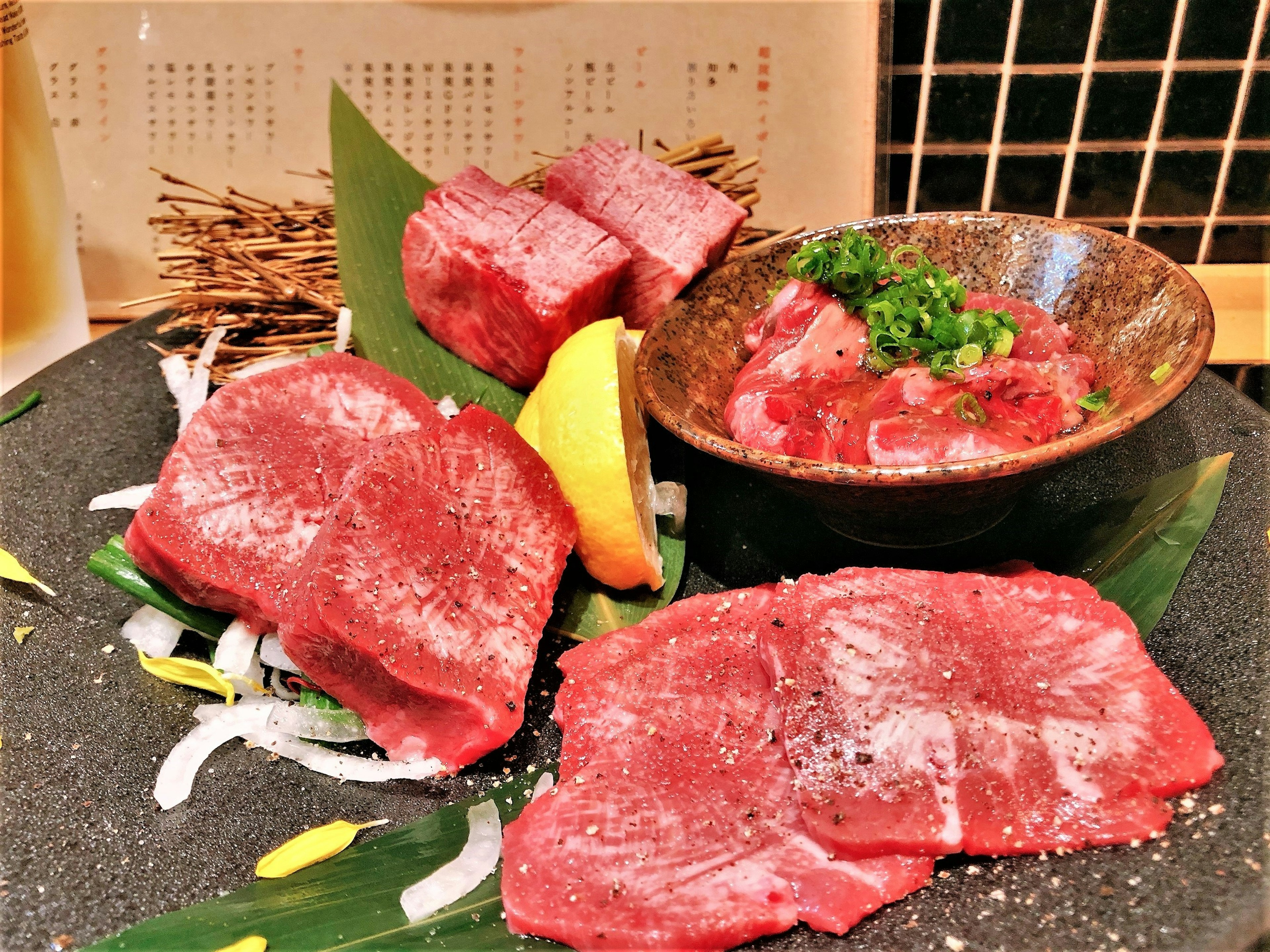 Fresh meat platter with sliced beef and a bowl of diced meat